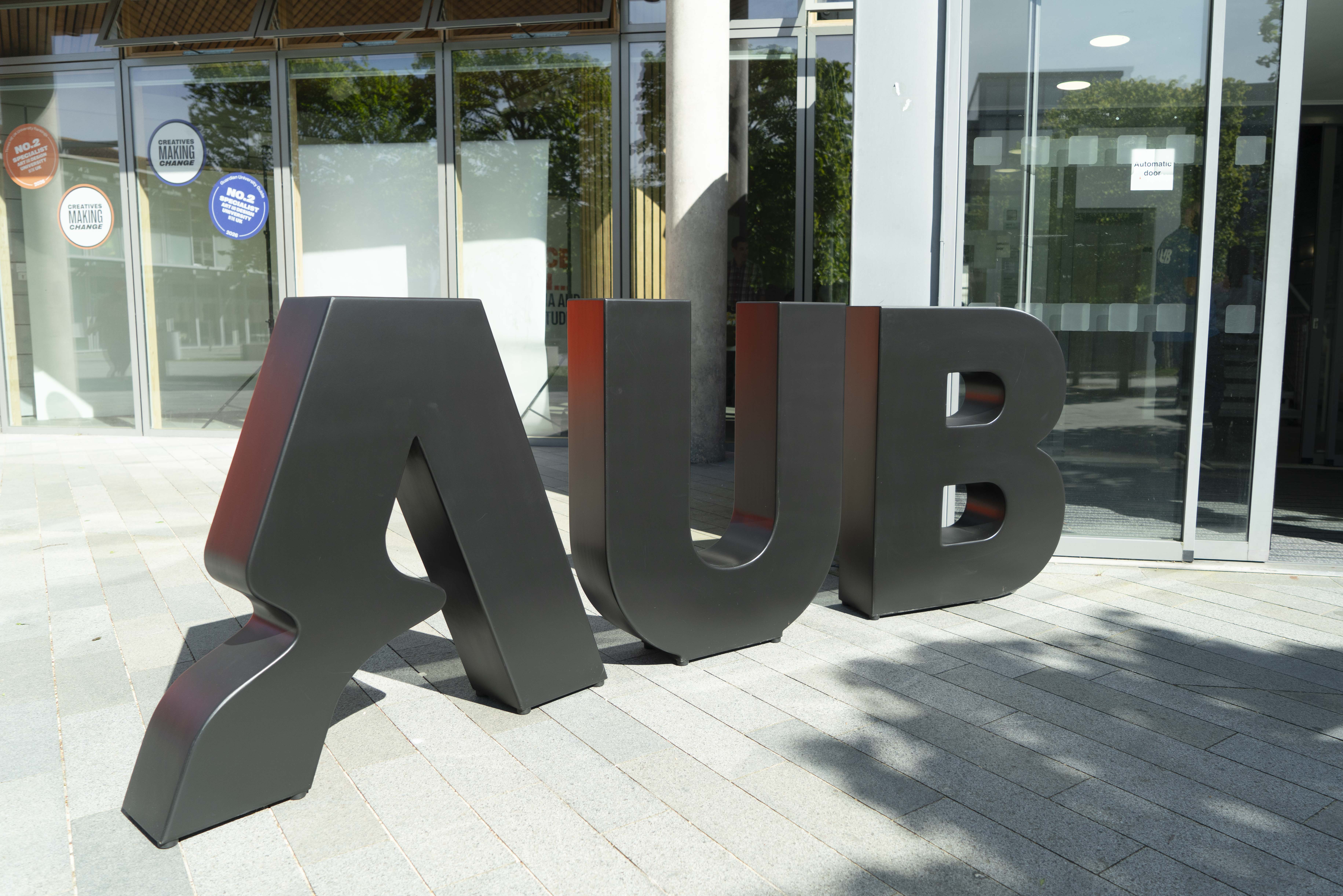 Giant letters spelling out AUB in the Arts University Bournemouth brand.