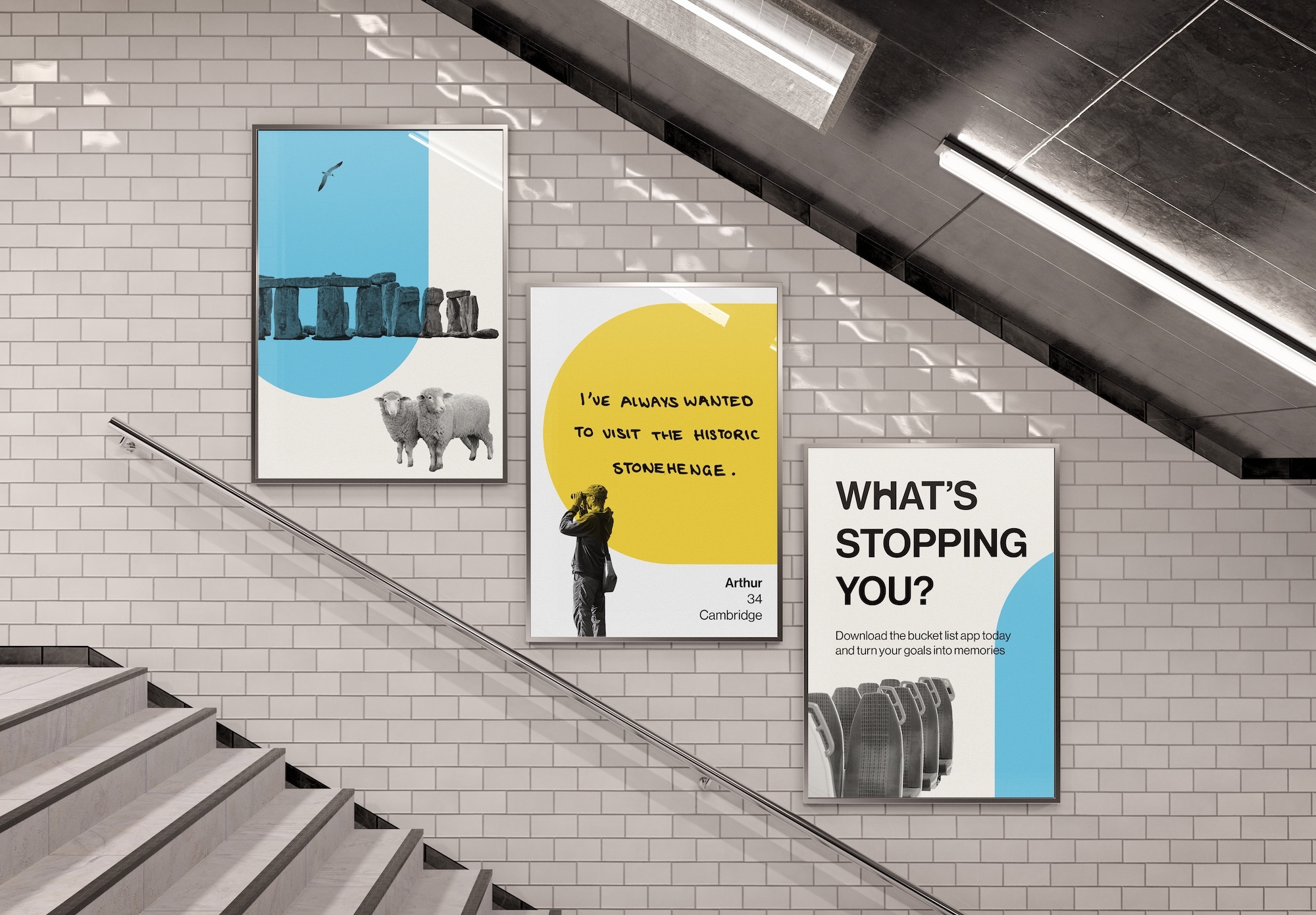 Three advertising posters on white tiled underground station wall beside staircase with metal handrail and fluorescent lighting.