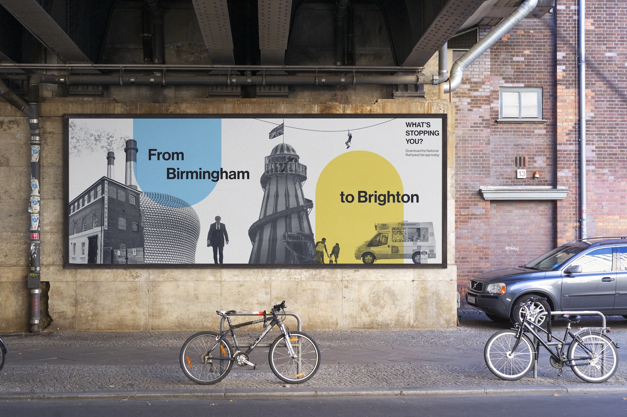 Large wall mural reading "From Birmingham to Brighton" with blue and yellow sections, industrial imagery, bicycles parked below, brick buildings.