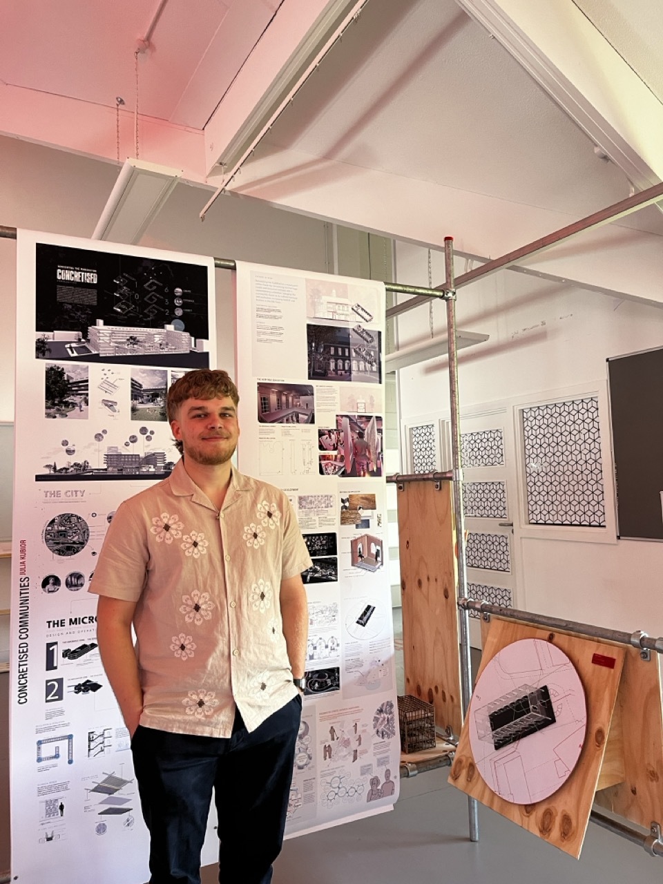 Oliver Dewes by his work at the Interior Architecture and Design Graduate space.