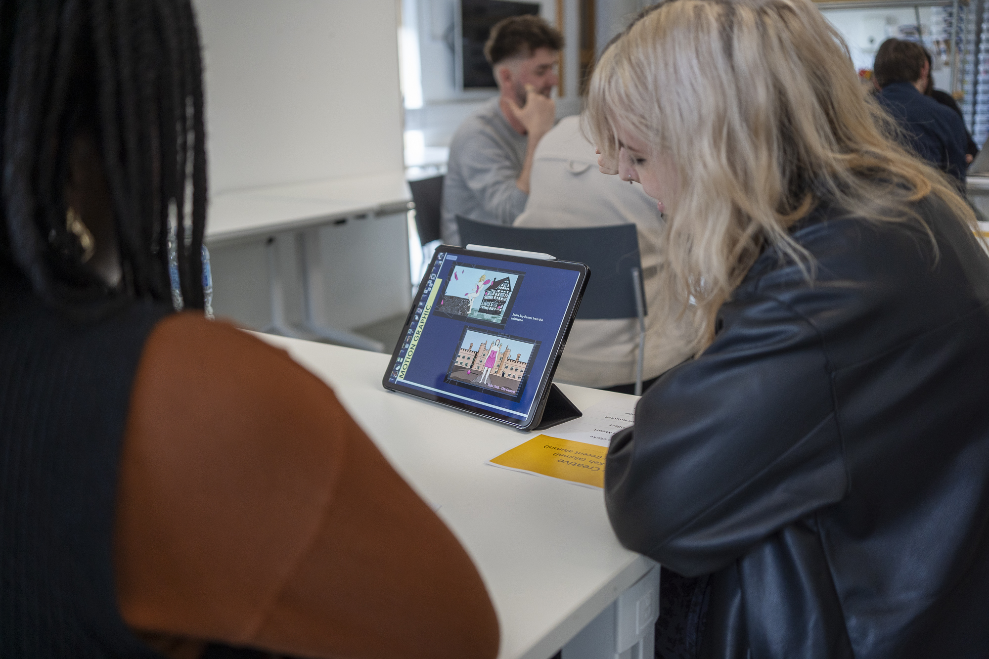 A BA (Hons) Graphic Design showing a Motion Graphics section of their portfolio on a tablet at the 2024 Graphic Design networking event.