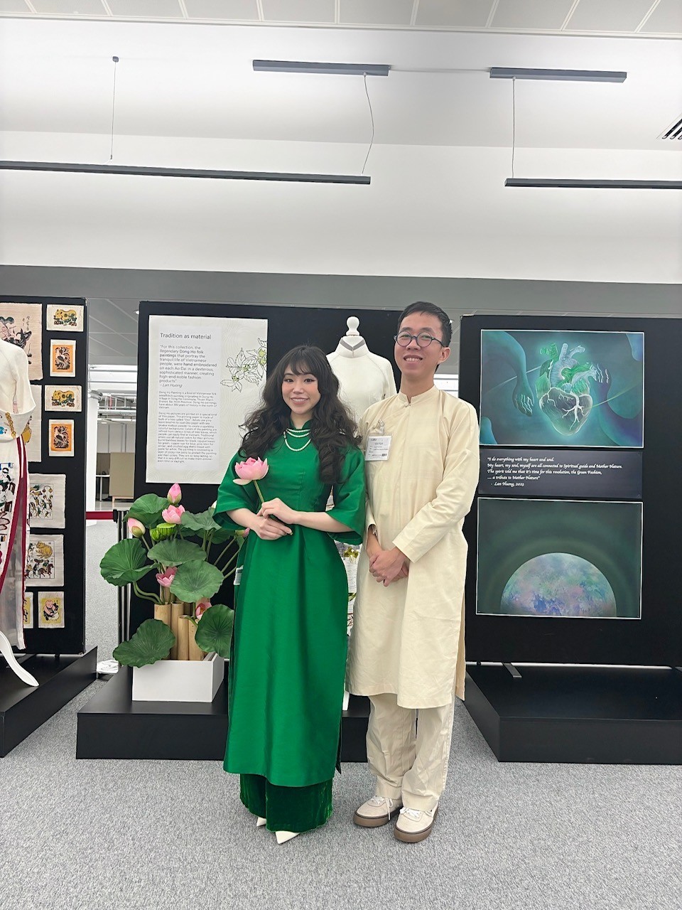 AUB MA Illustration student Minh Hieu Nguyen poses for a photo with Mai Khanh Tran at the Green Fashion exhibition.
