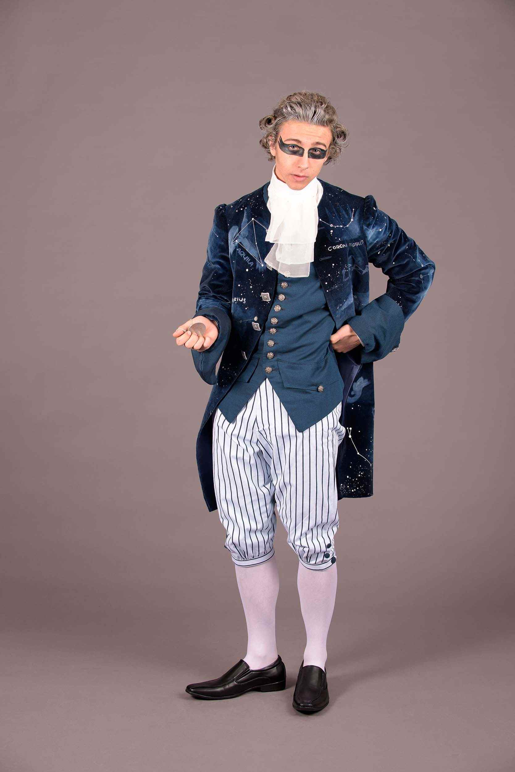 A person standing against a plain background in 18th century costume.