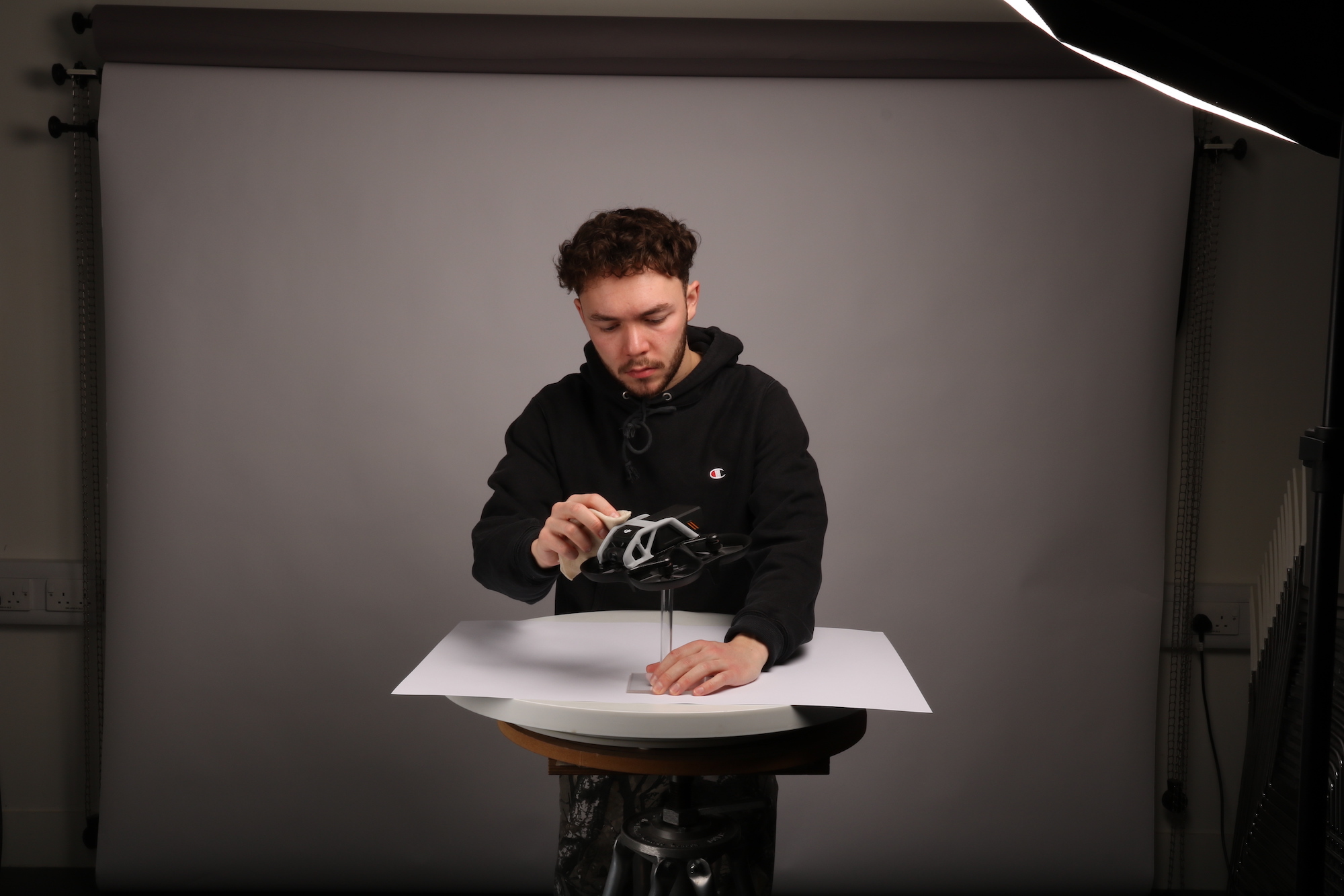BA (Hons) Modelmaking student H. Carter with his current final project on a table in front of him.