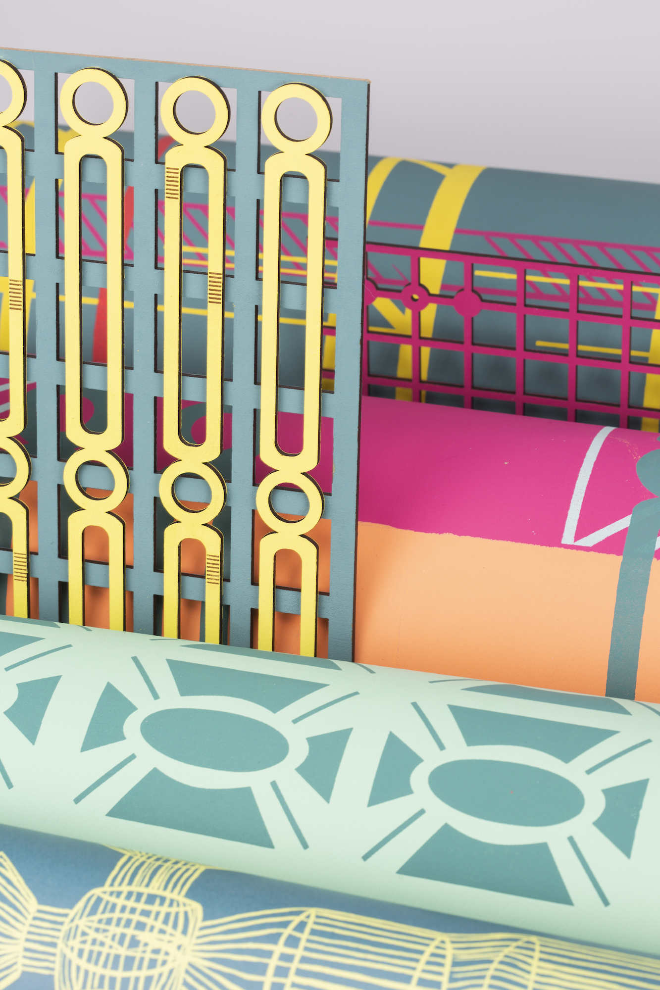 Geometric textile patterns, blue, yellow and pink.