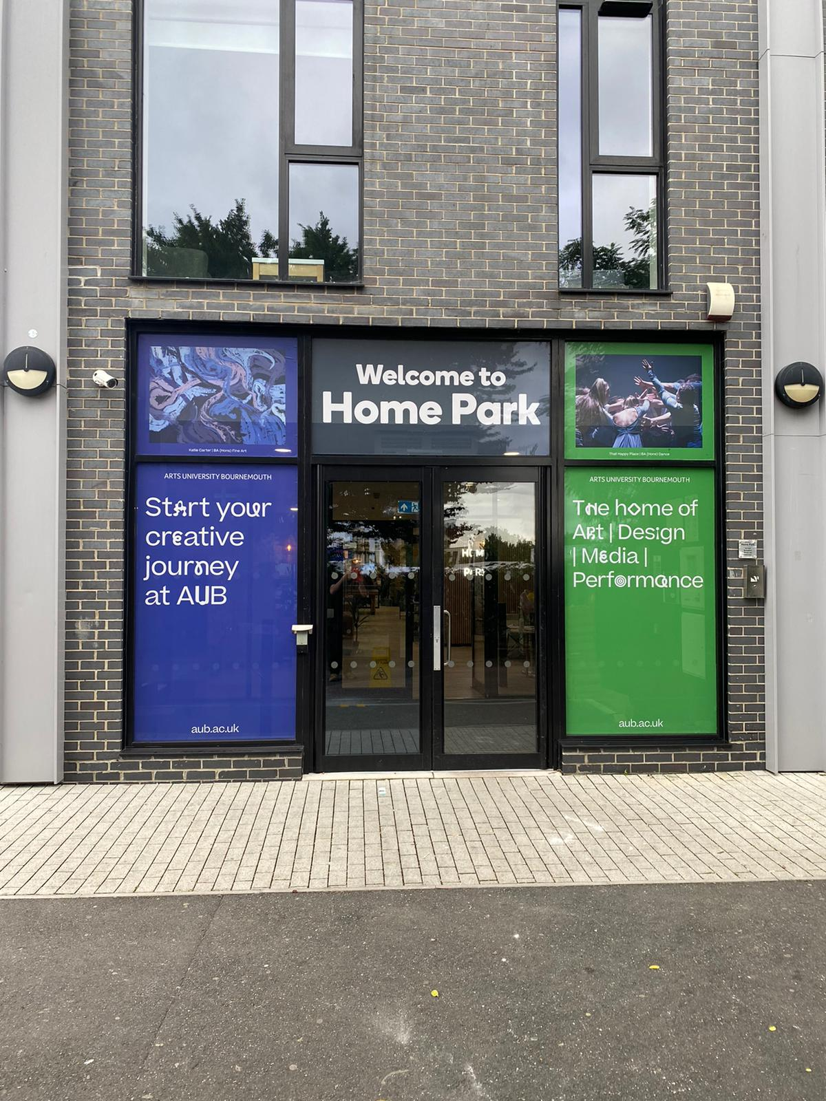 The entrance to a university accommodation building. The words "Welcome to Home Park" appears over the doors.