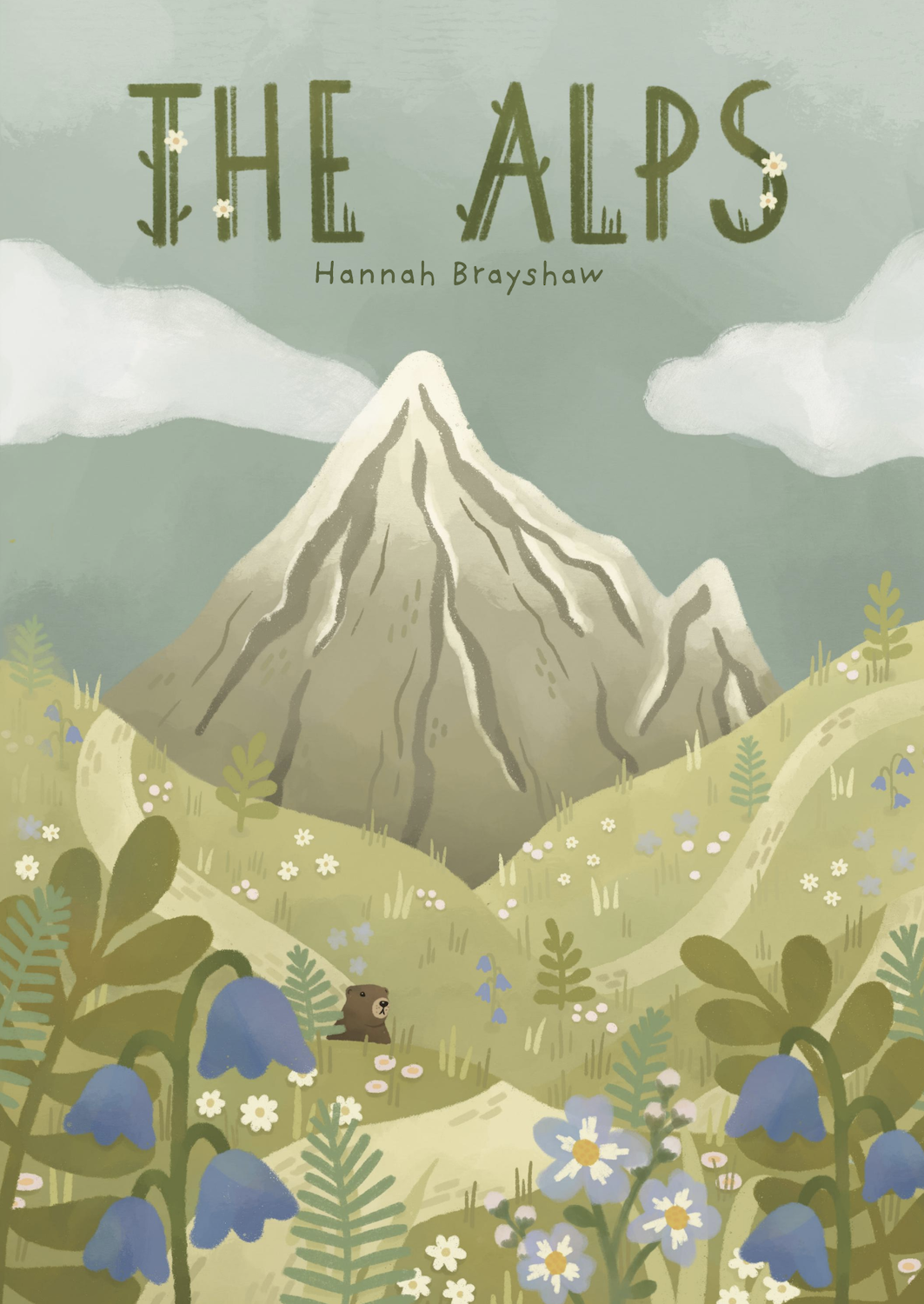 Book cover illustration showing grey mountain peak with white clouds above. Green text reads "THE ALPS" with "Hannah Brayshaw" below. Foreground features green meadow with blue flowers, white daisies, and small brown animal figure.