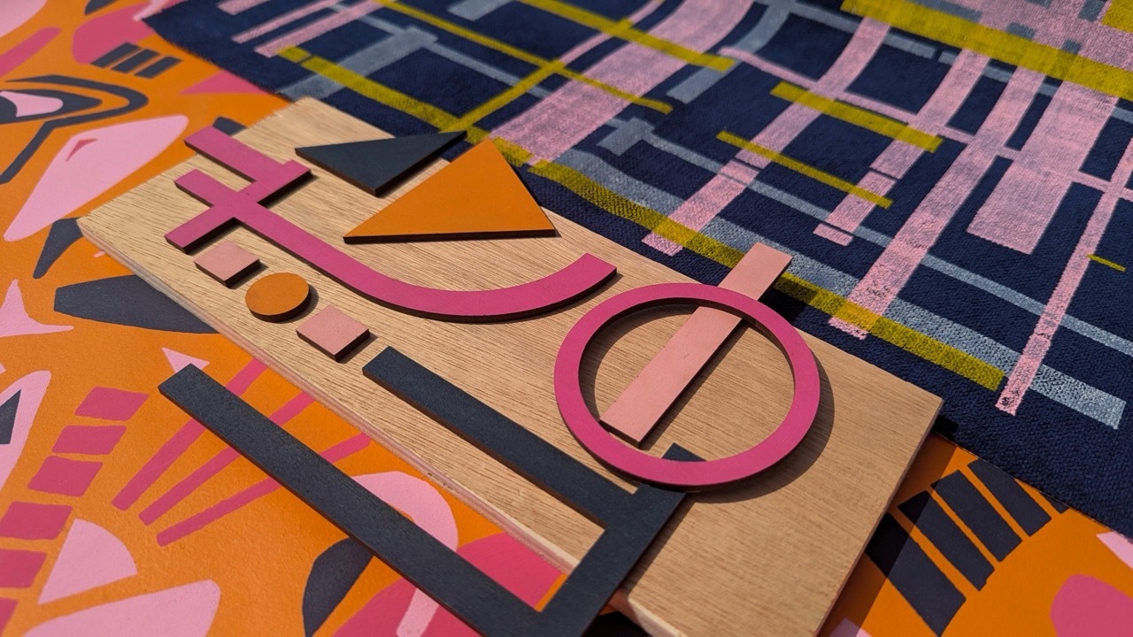 Abstract geometric composition with intersecting rectangular shapes in pink, navy blue, orange, and beige. Features curved lines, circles, and triangular forms overlapping in angular arrangement.