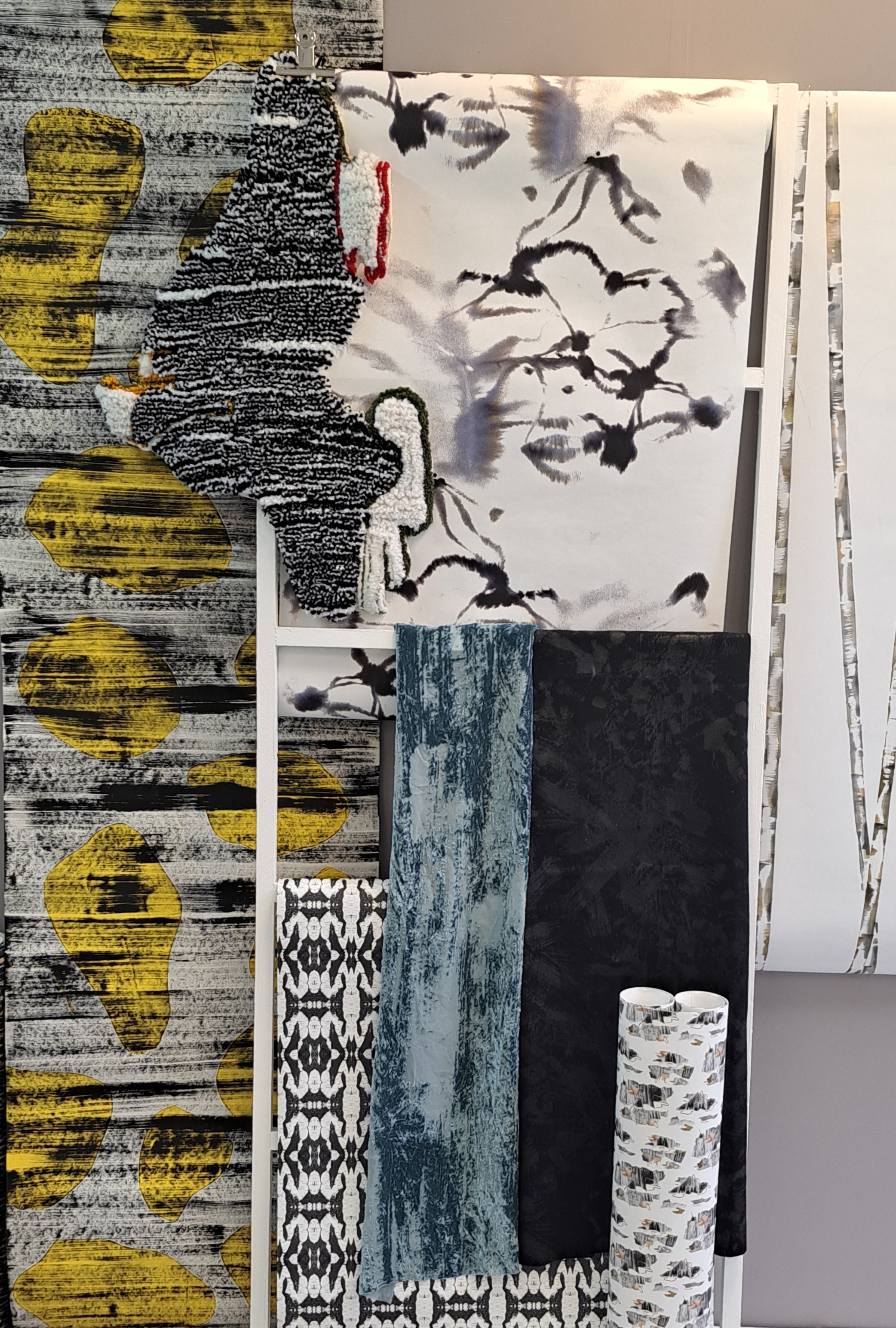 Several samples from the collection "Wetlands" – rolls of fabric with abstract patterns.