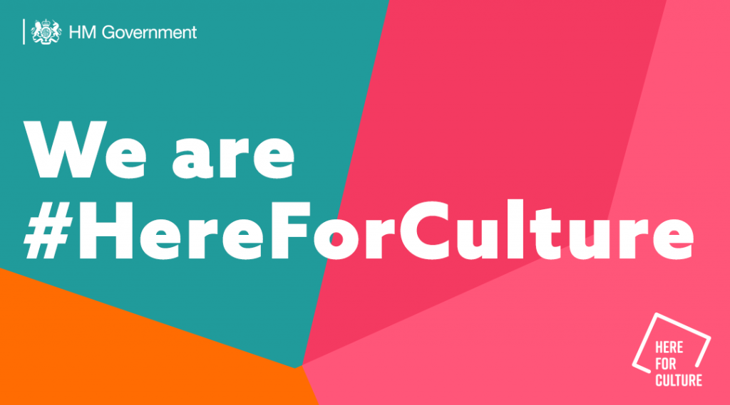 Green, orange and pink banner from HM Government with white text reading "We are #HereForCulture" in the centre.