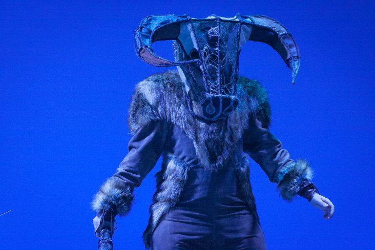 Actor on stage in costume as a Minotaur with a bull's head mask.