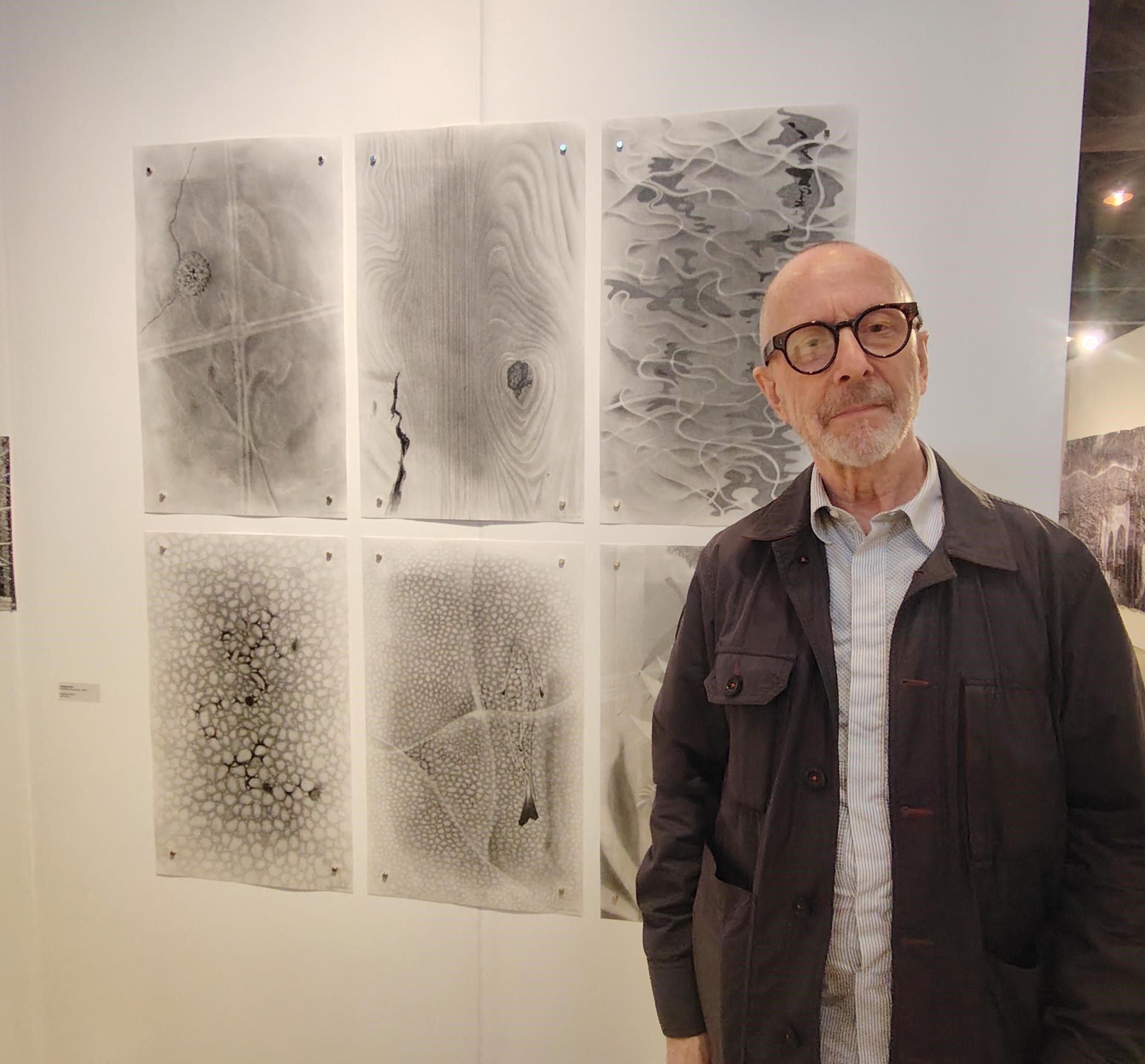 R Gregory next to six of his drawings at the Trinity Buoy Wharf Drawing Prize 2026
