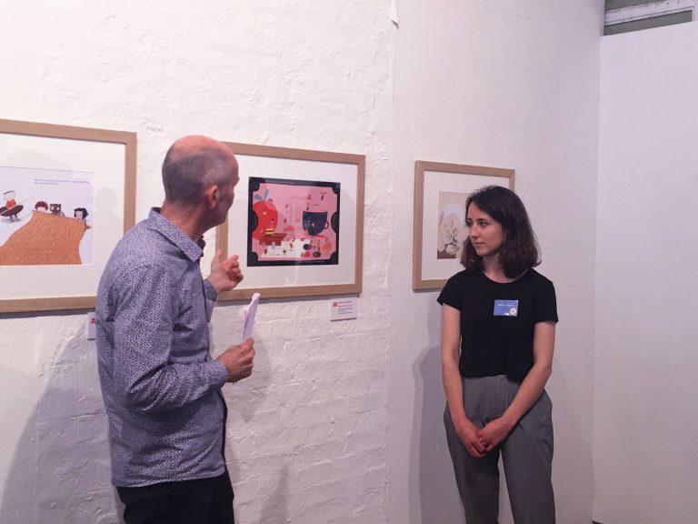 judges Chris Innis alongside her work