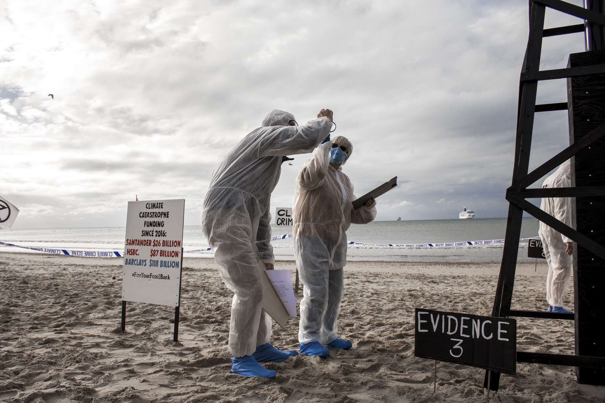 Extinction Rebellion protesters take part in a protest on Bournemouth beach