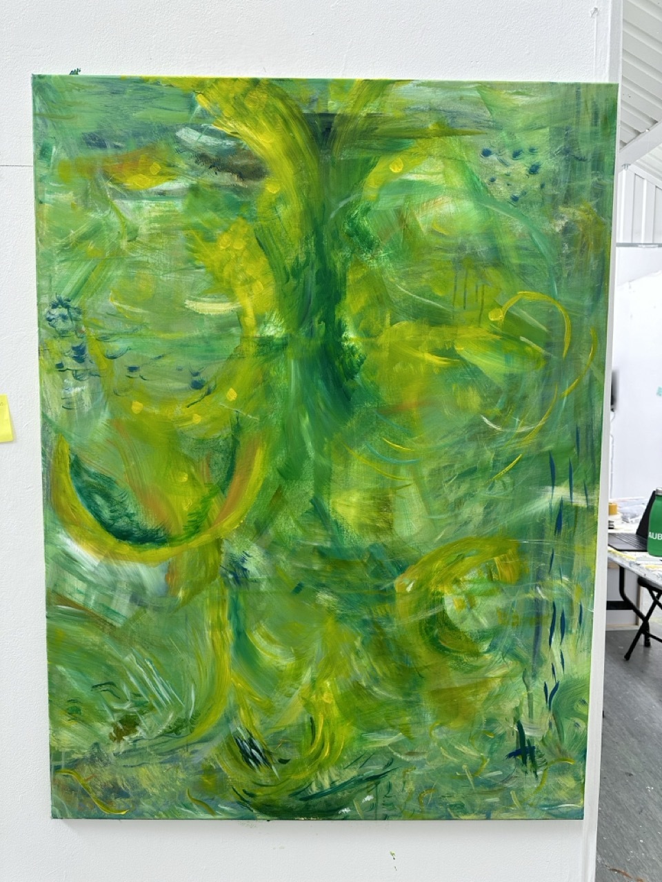 Abstract green painting on a canvas, white background.