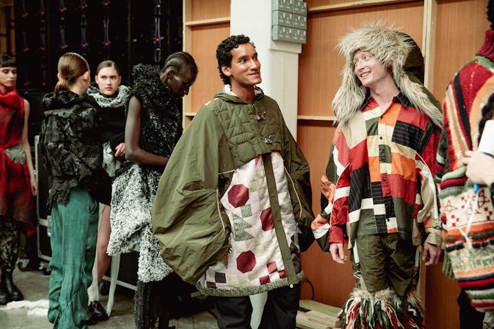 Models lined up for the GFW catwalk wearing layered, colourful clothing by Nicole Singleton.