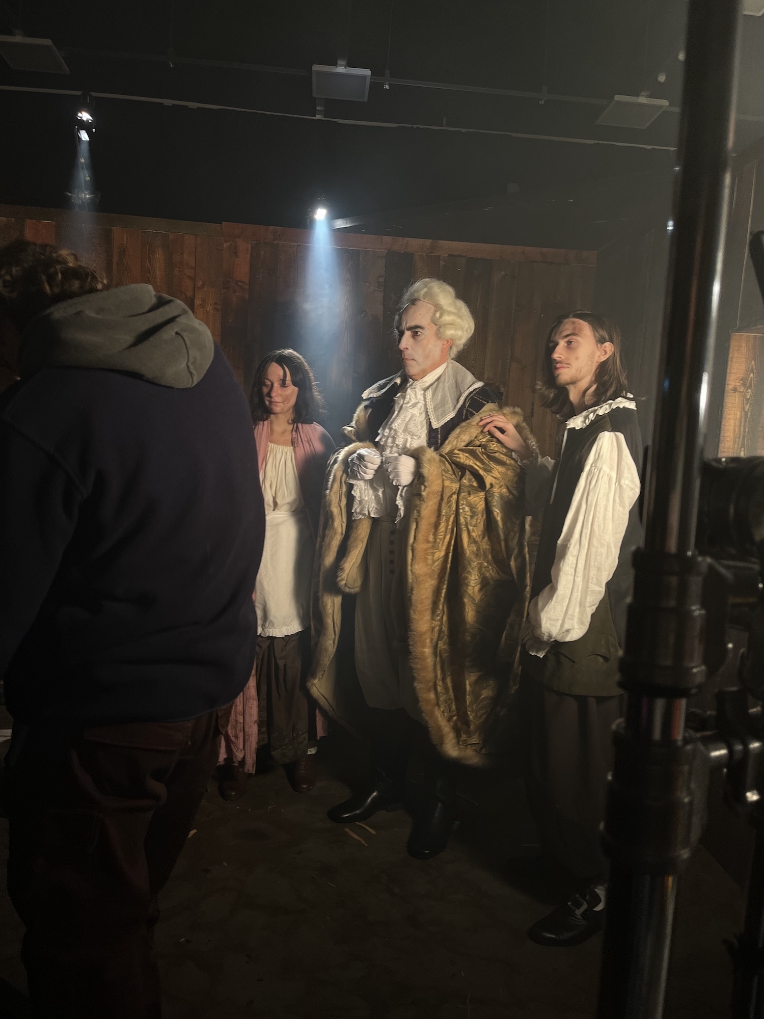 Three actors dressed in 18th century-style costume on set of the BA (Hons) Film Production commercial "Bon Appetit".