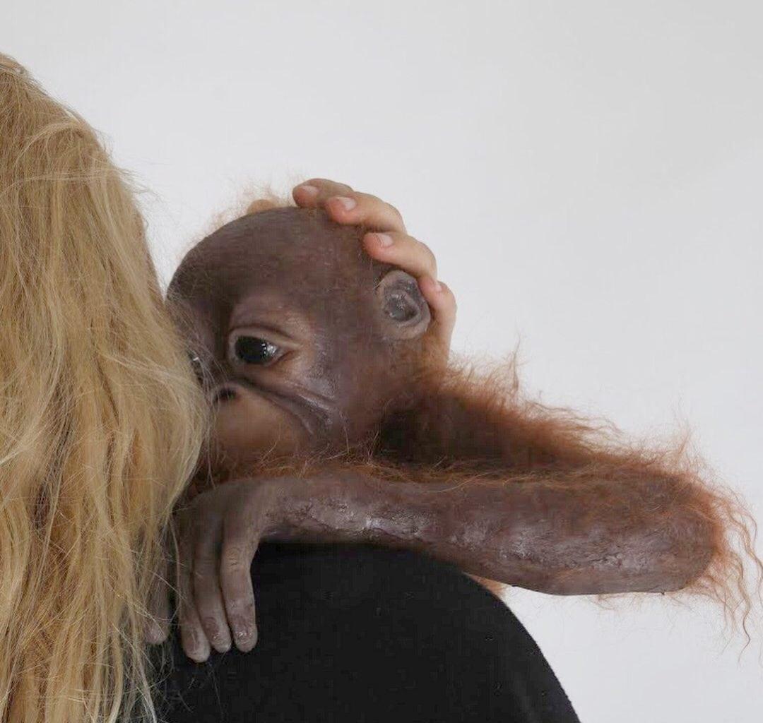 Lady holding a baby monkey