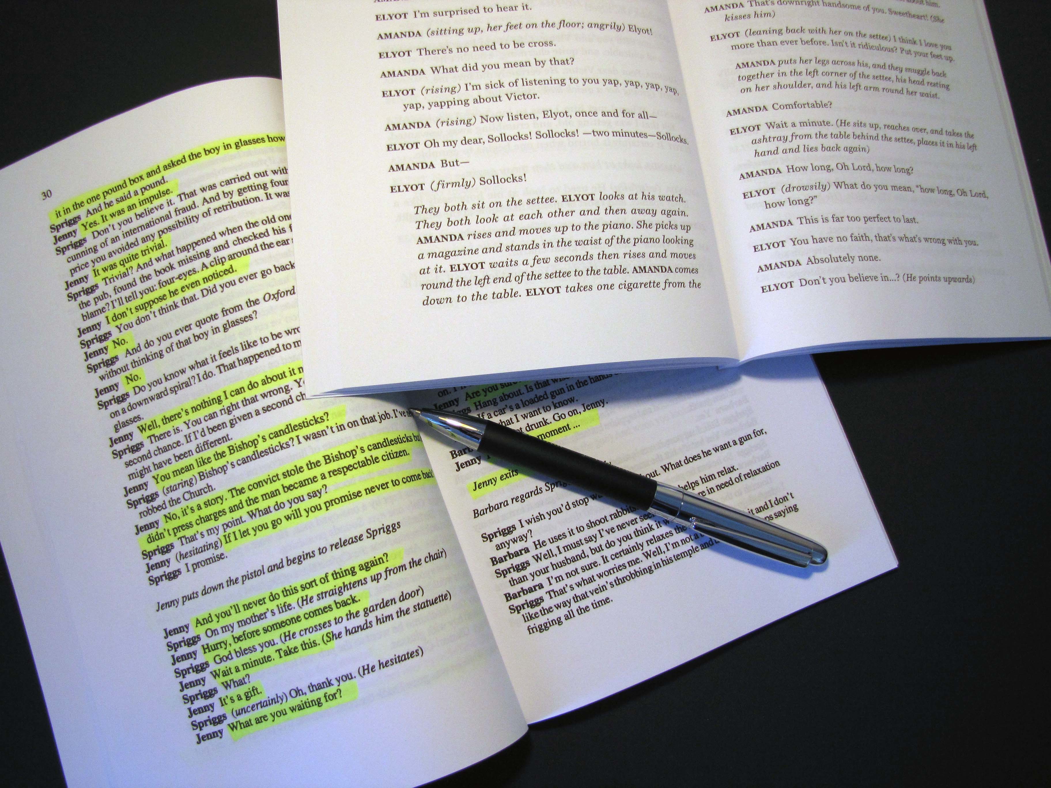 Two open scripts on a table