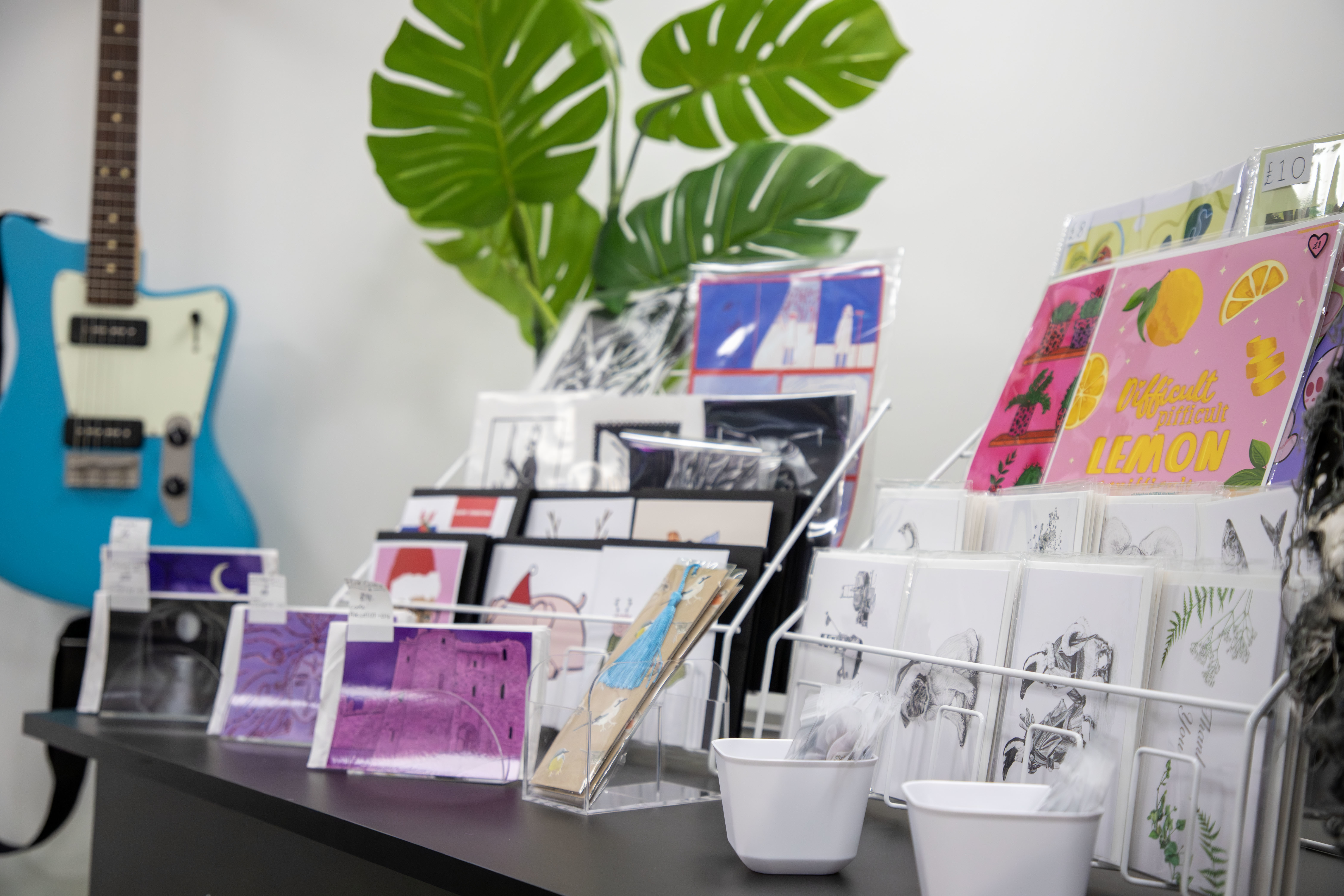 Stacks of illustrated prints on display in the #AUBMakers pop-up shop in Poole.