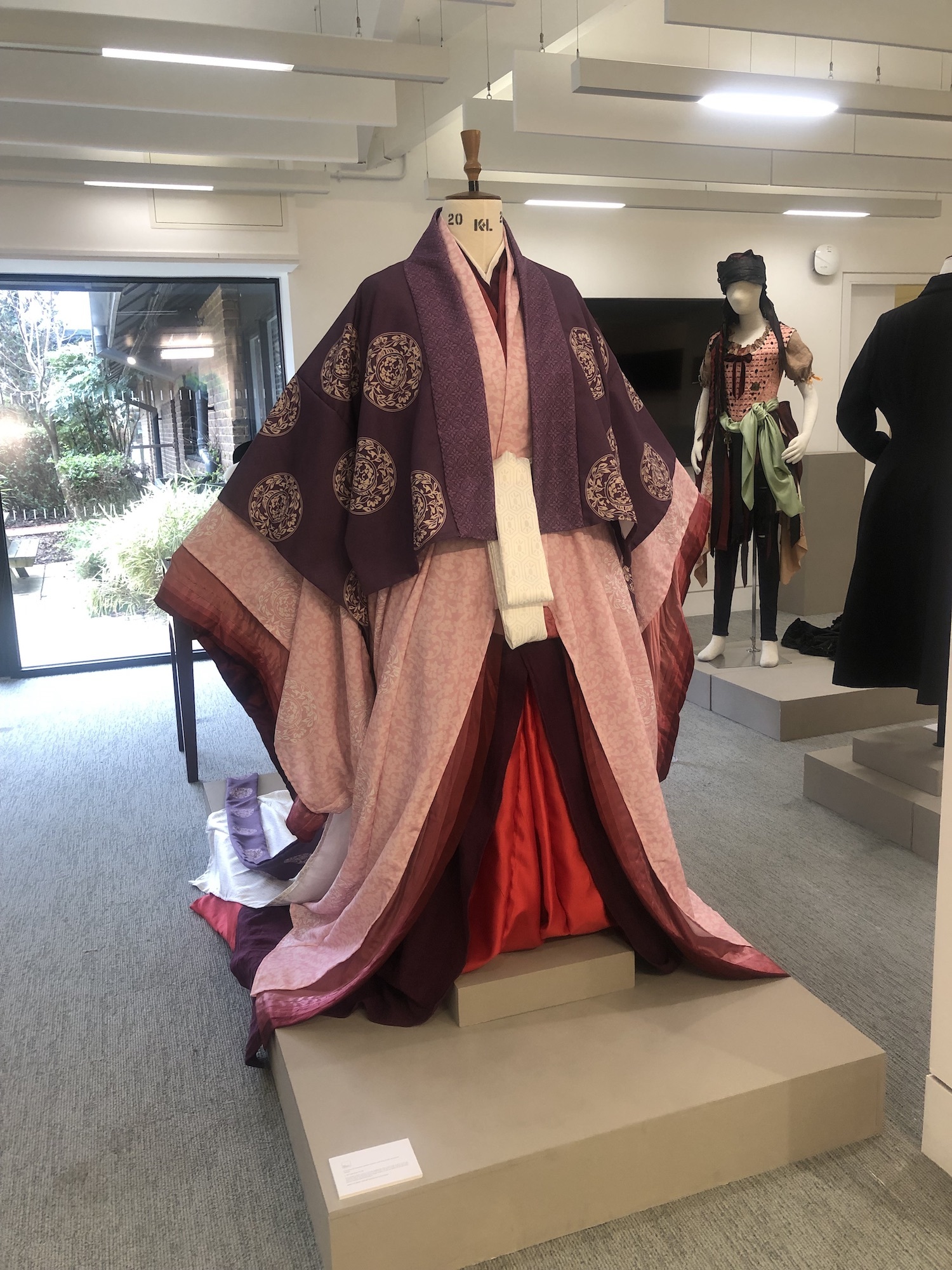 A mannequin dressed in a pink and purple Japanese-style costume.