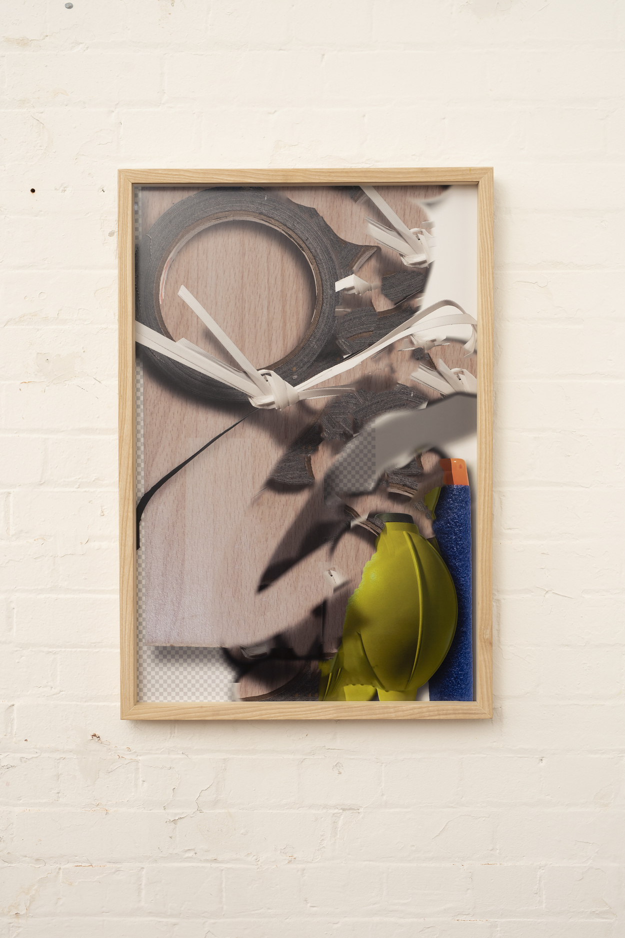 Abstract photographic image in a frame against a brick wall.