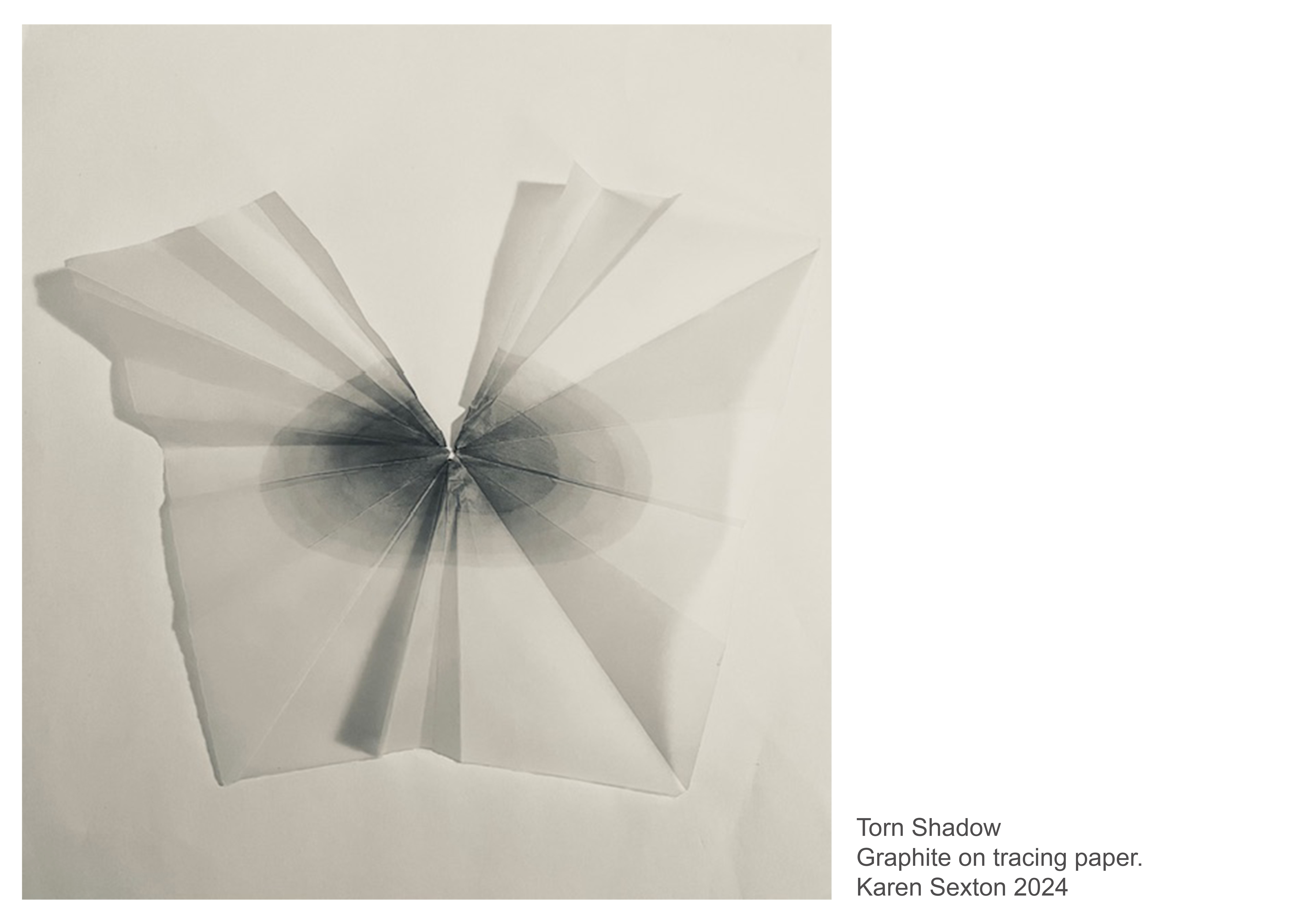 Abstract, shaded circle on a piece of torn and folded tracing paper.