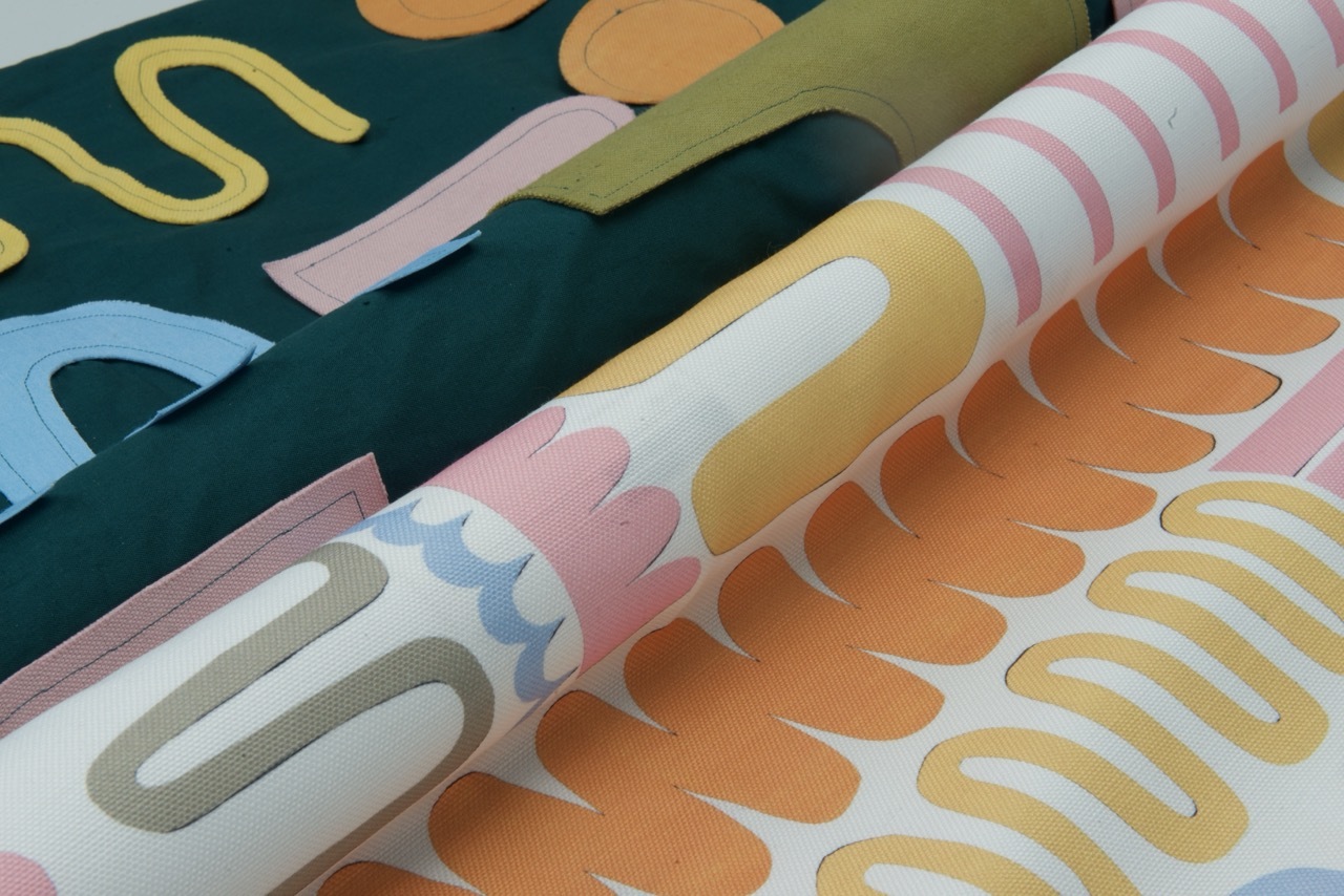 Close-up image of a digitally printed fabric alongside an appliqued fabric.