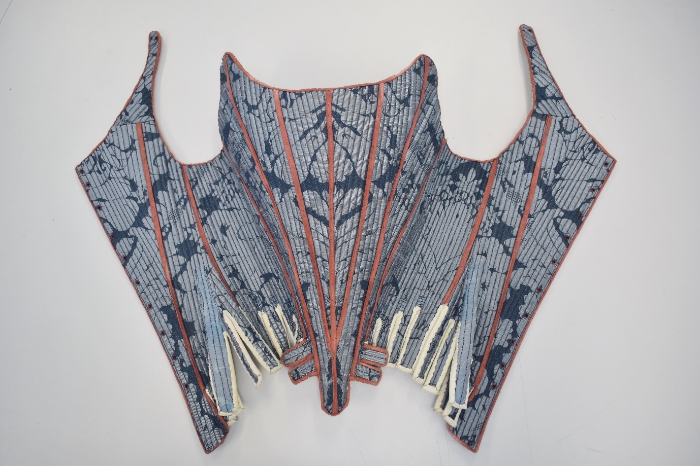 Reconstructed eighteenth-century stays with blue and orange detailing.