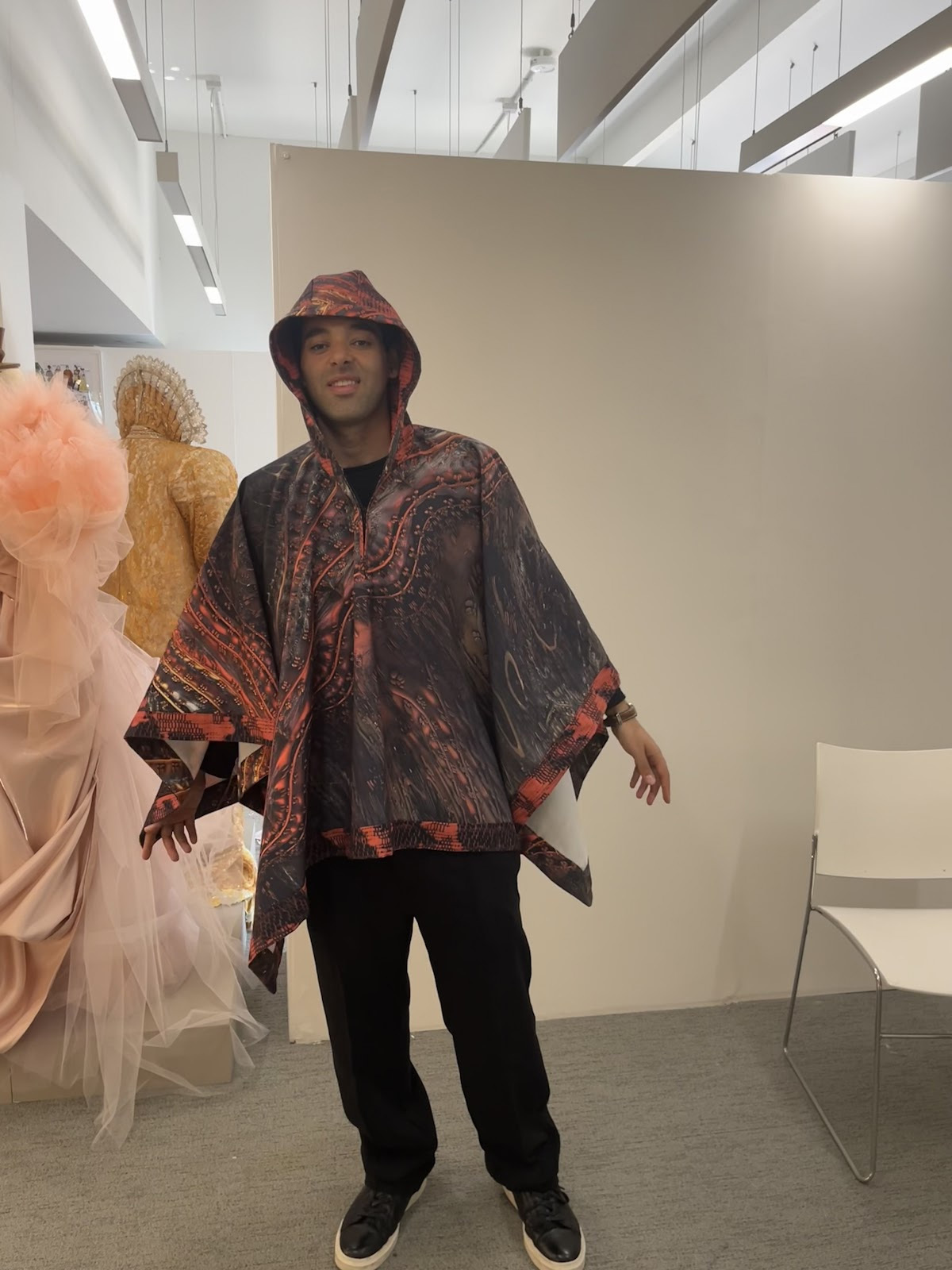 I. Sousa wearing a hooded poncho with an abstract design at TheGallery, AUB Campus.