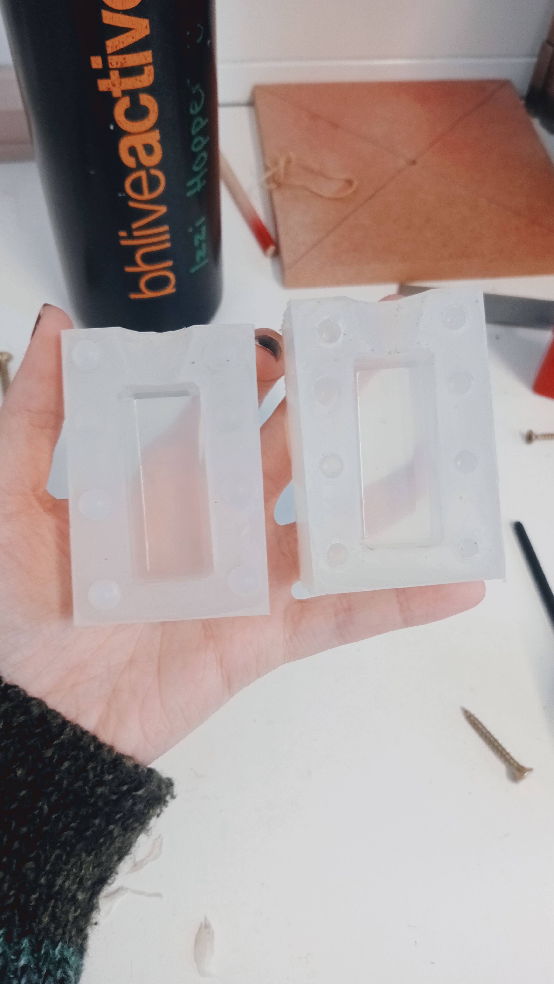 Shaped glass blocks held in someone's hand.