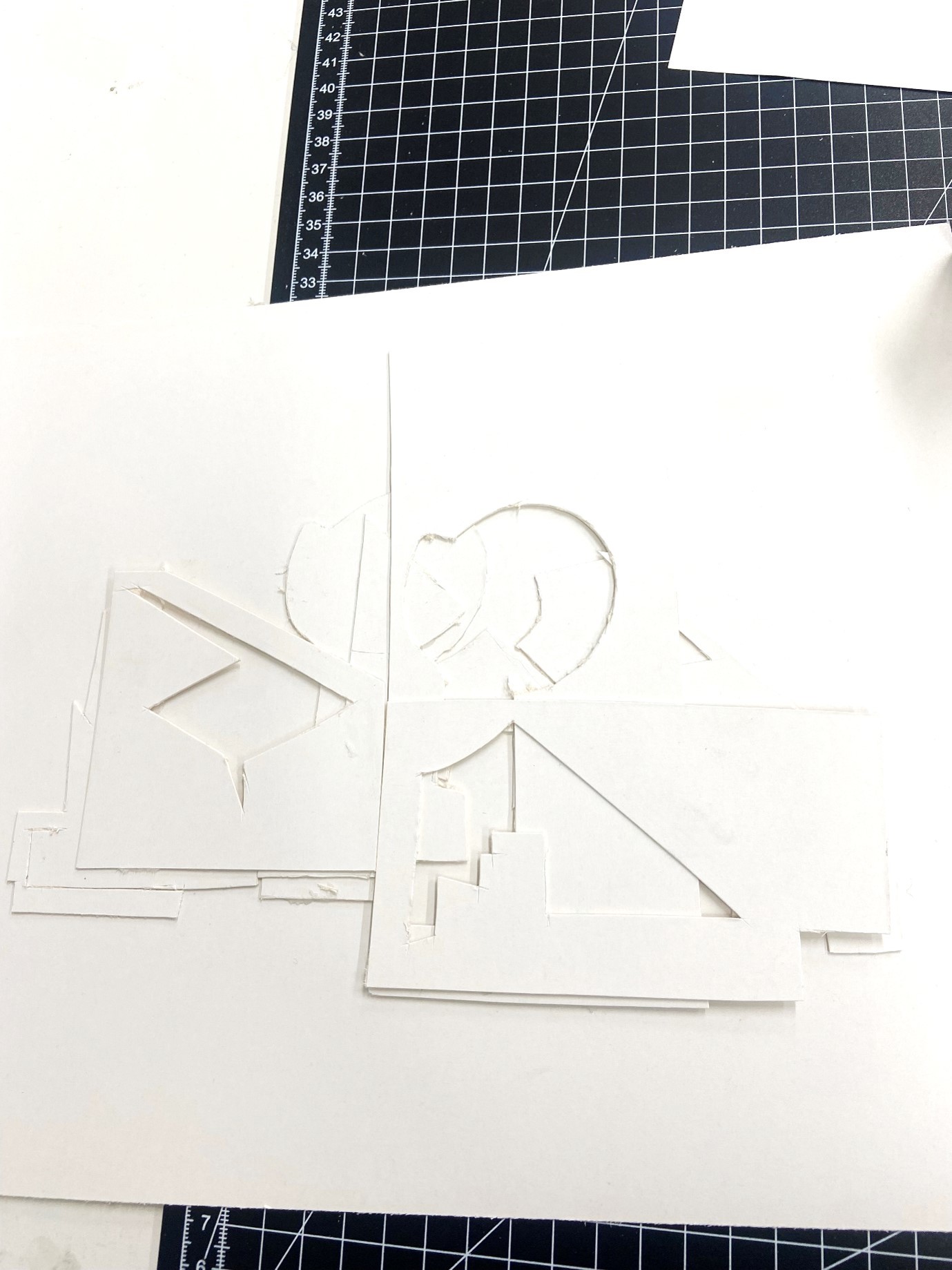 A set of abstract shapes constructed out of white card.