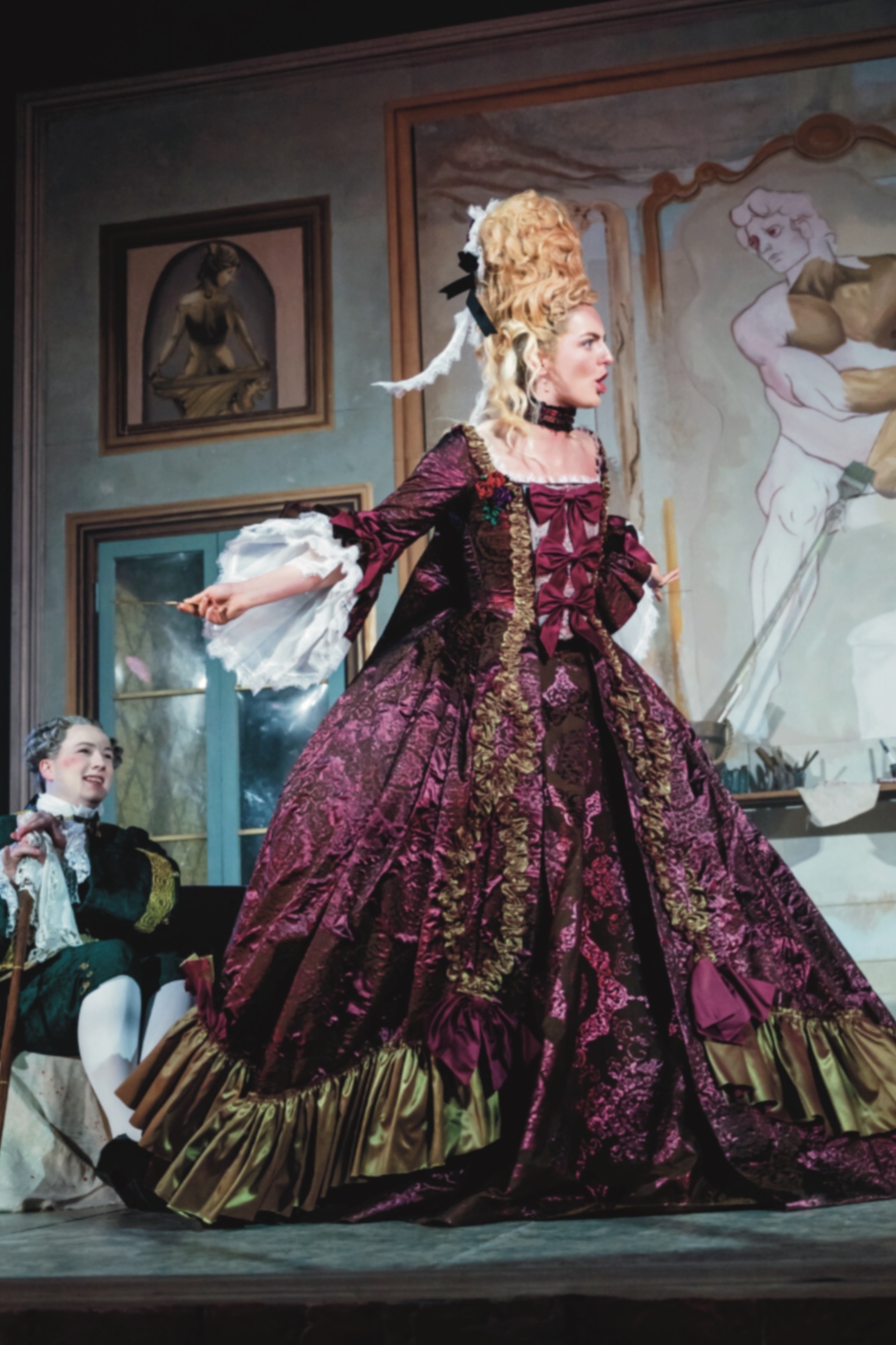 BA (Hons) Acting student playing Cecilia in La Casa Nova. She is dressed in 1700s costume, looking angry and is pointing.
