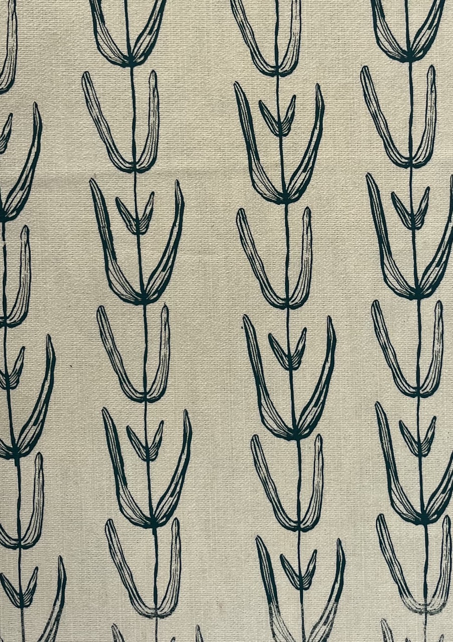 A fabric with a repeating floral pattern featuring elongated leaves and stems in dark green on a light beige background. The design consists of vertically arranged, abstract leaf shapes.