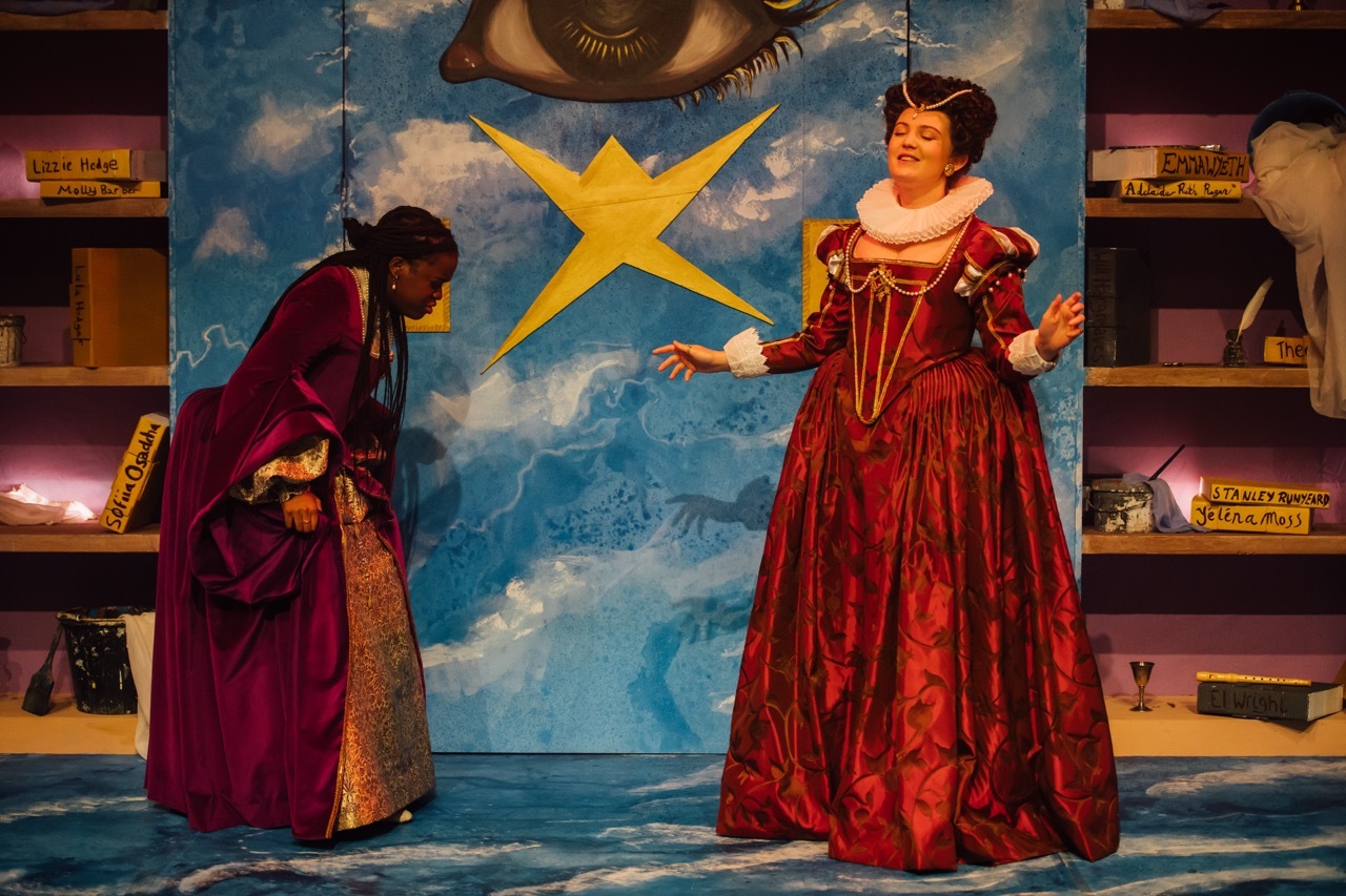 Mary Sidney, portrayed by Sarah Astbury, and Emilia 2, played by Kimberly Msawka. I made Mary Sidney’s red Elizabethan gown and ruff. Her gown is a crimson colour, printed with pomegranates and vines. The bodice is trimmed with gold braid and pearls.