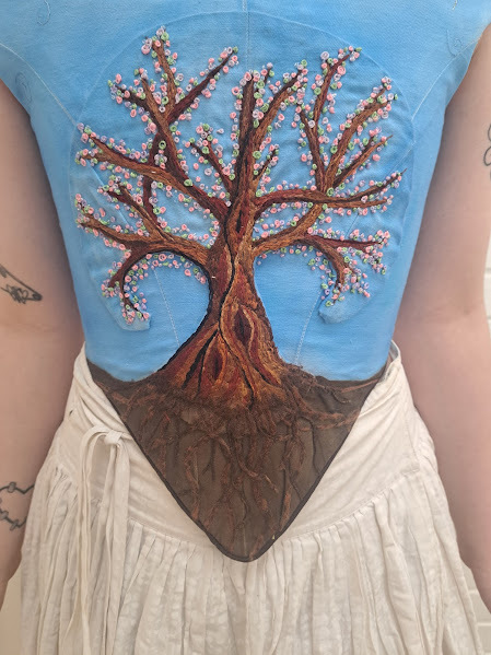 My 1660ss heavily decorated bodice. This included hand painted material, hand sewn background swirls and a hand embroidered and beaded tree.