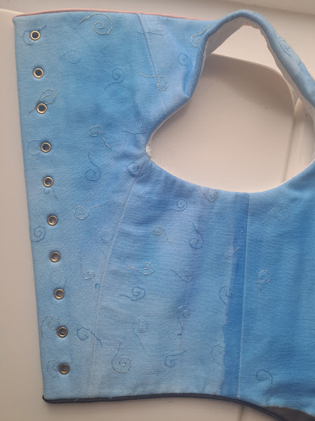 This view shows the background of the fabric which I hand painted, and hand sewed on the swirls.