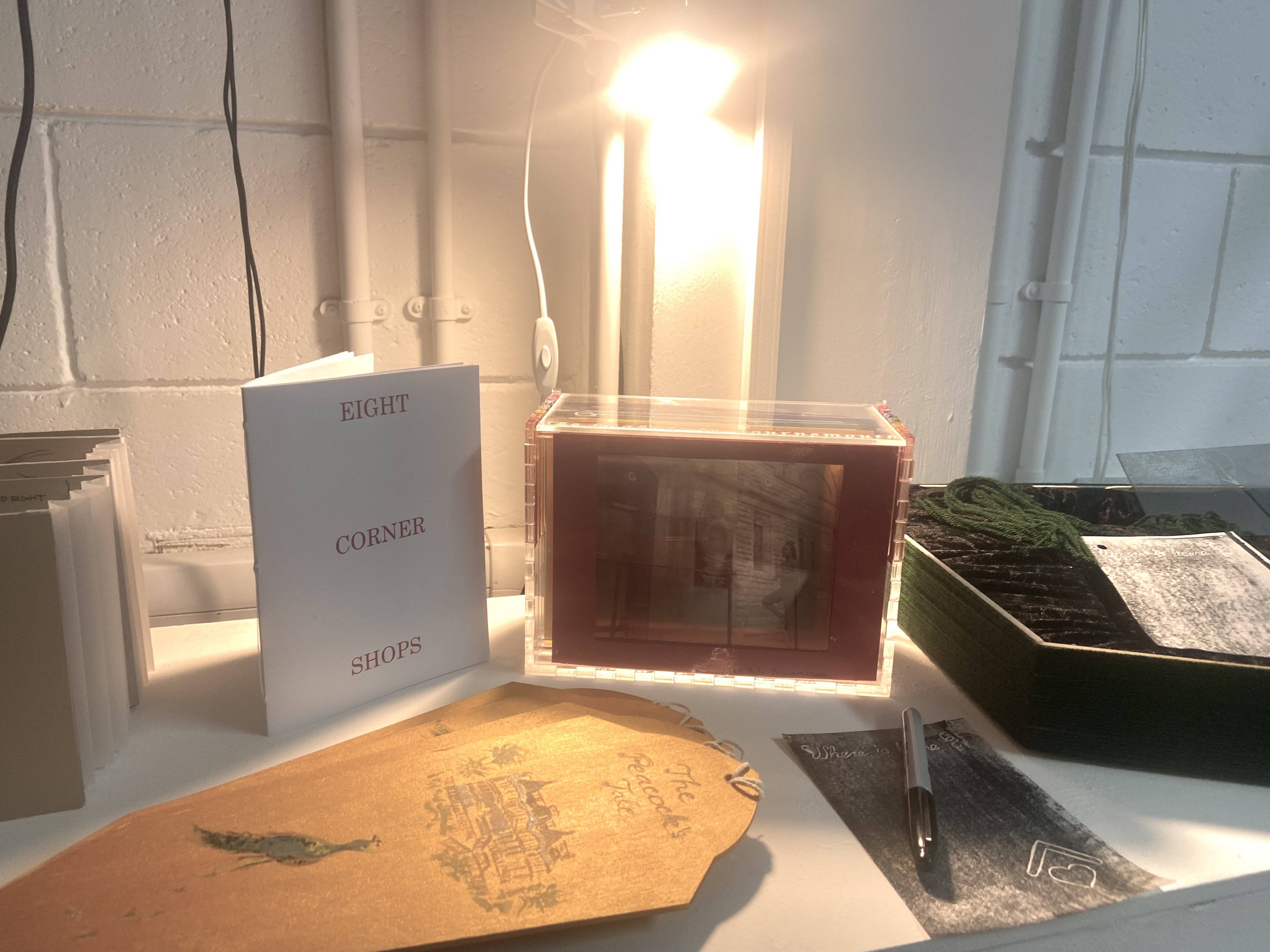 A display of architecture work at the 2024 AUB Summer Shows, including a booklet entitled "Eight Corner Shops".