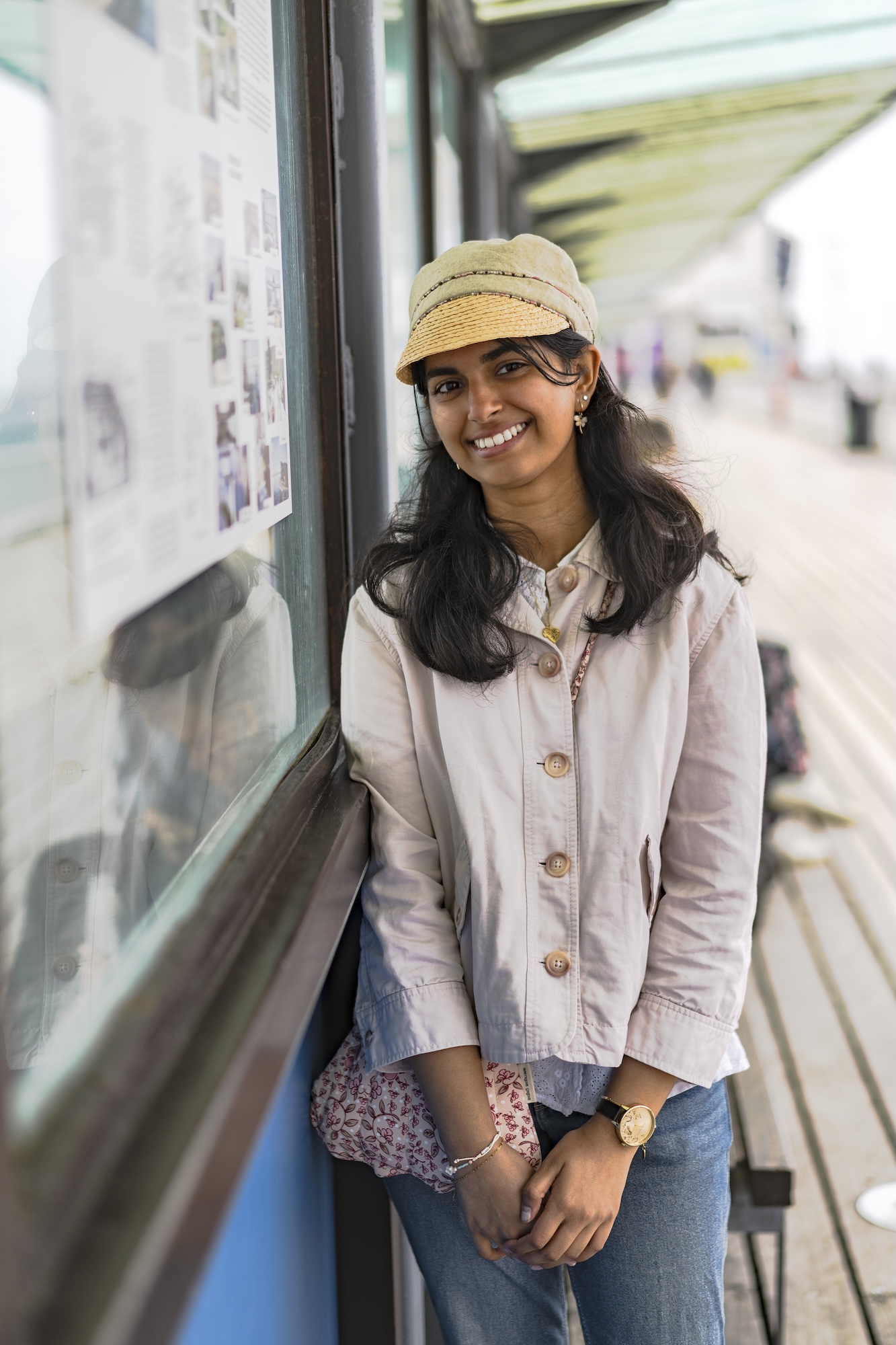 Portrait of J Gajjar standing next to a display board on Bournemouth Pier.