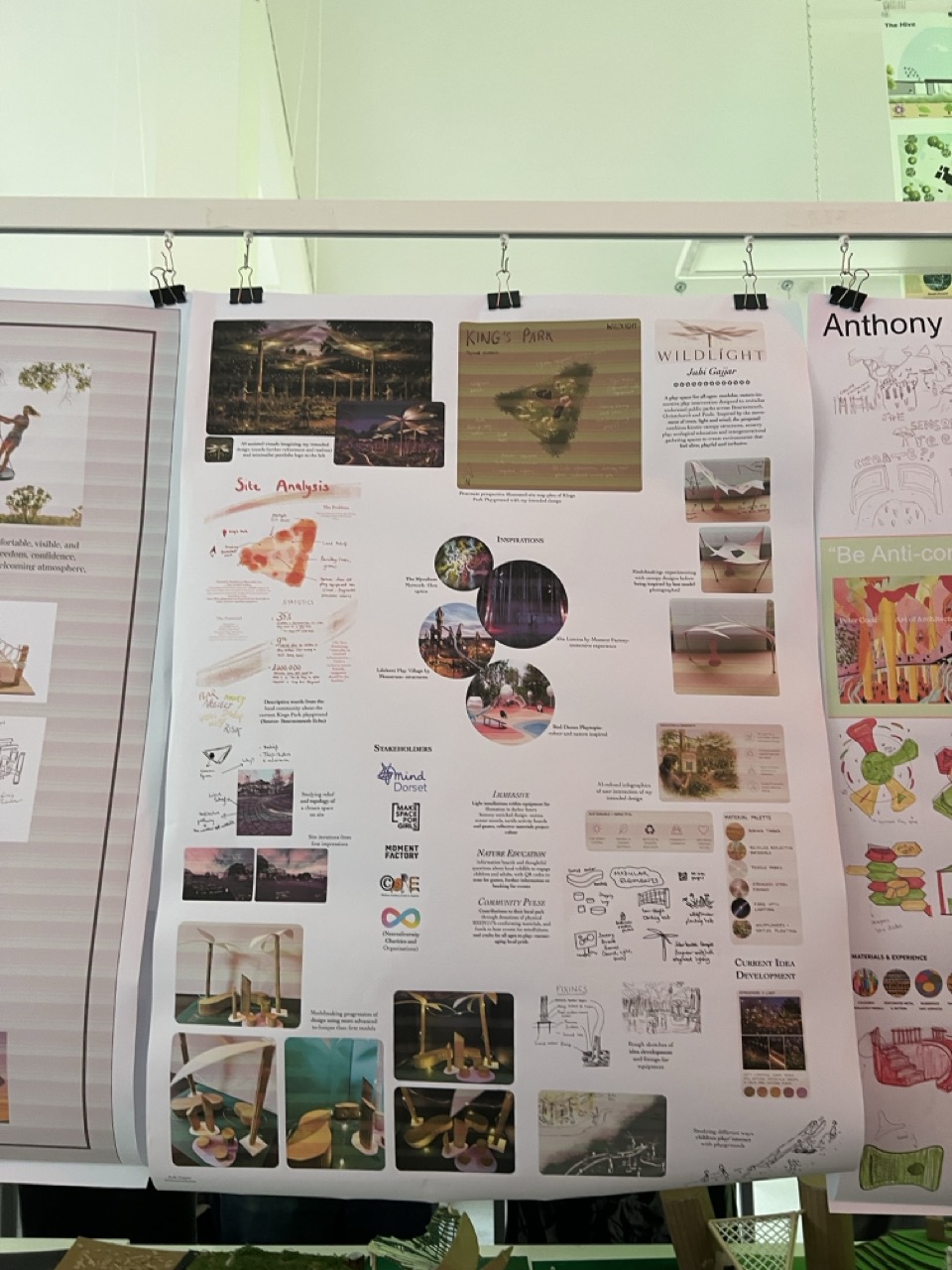 A display board featuring various images and text related to a project. It includes photographs of nature, diagrams, and written content focusing on design elements and concepts. The background contains structured designs and illustrations.