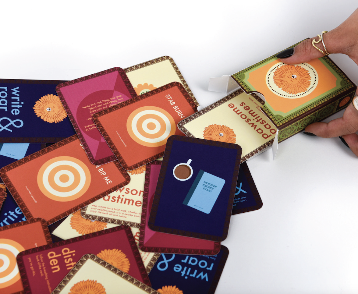 A deck of cards with colourful designs laid out on a plain surface.