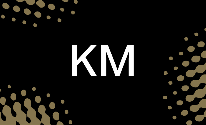 Black and gold banner with the white text "KM" in the centre.