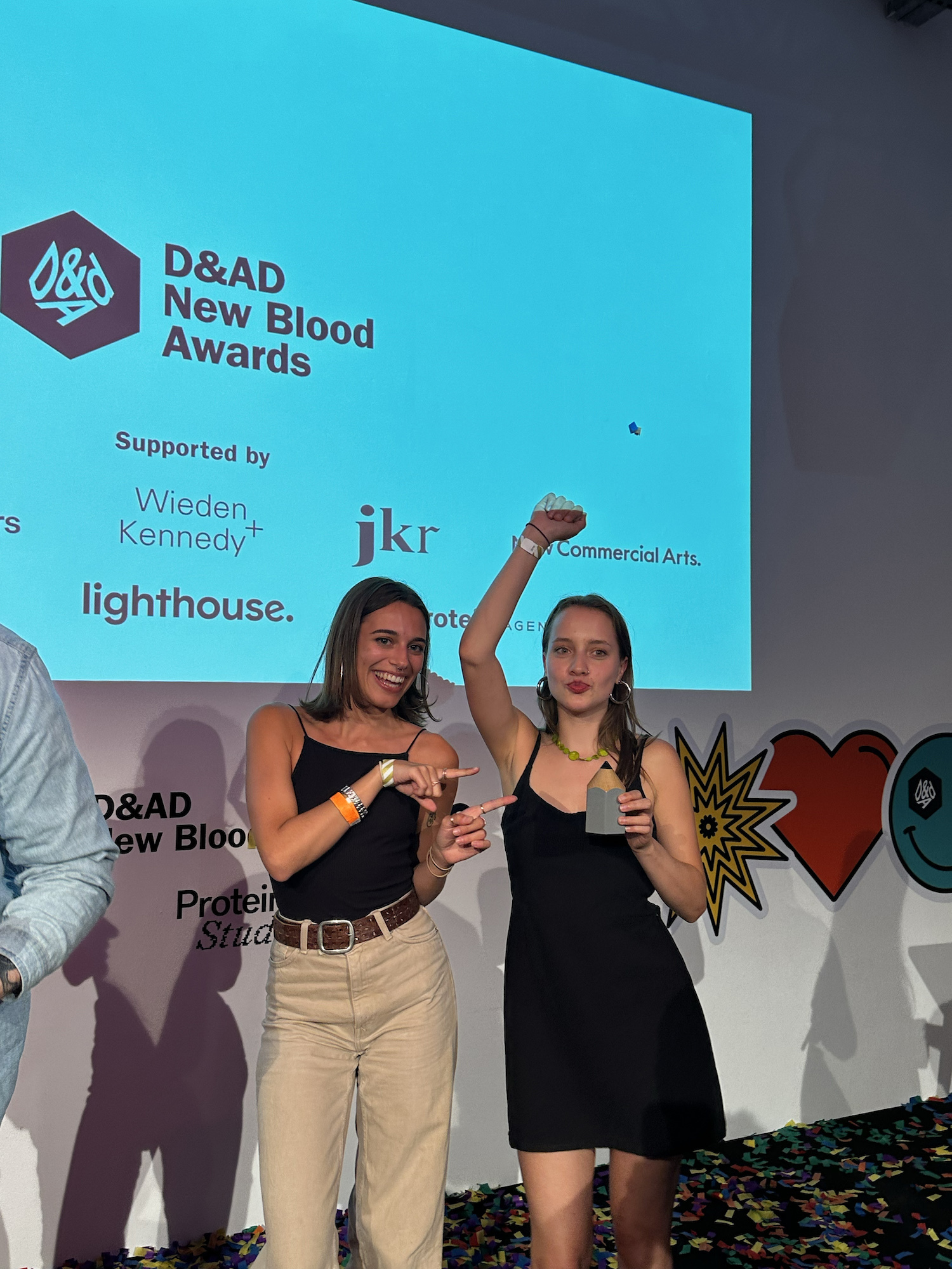 BA (Hons) Graphic Design students K Noren and K Ptasinska posing for a photo with their award at the 2024 D&AD New Blood Awards.