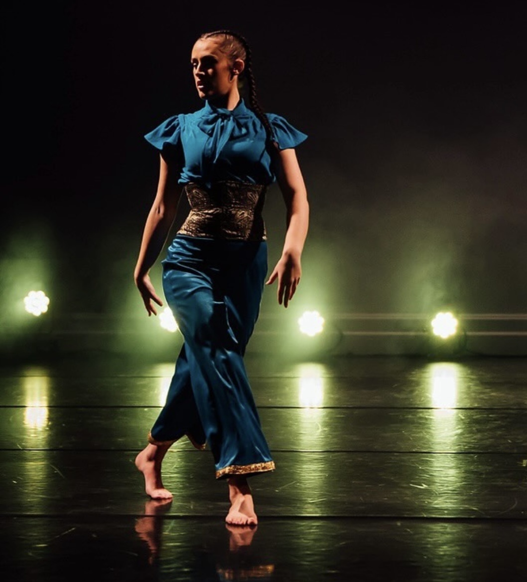 Professional photography from the dance production of DIVA, highlighting the costume during performance. The costume had been made with elements of stretch fabric for ease in movement.