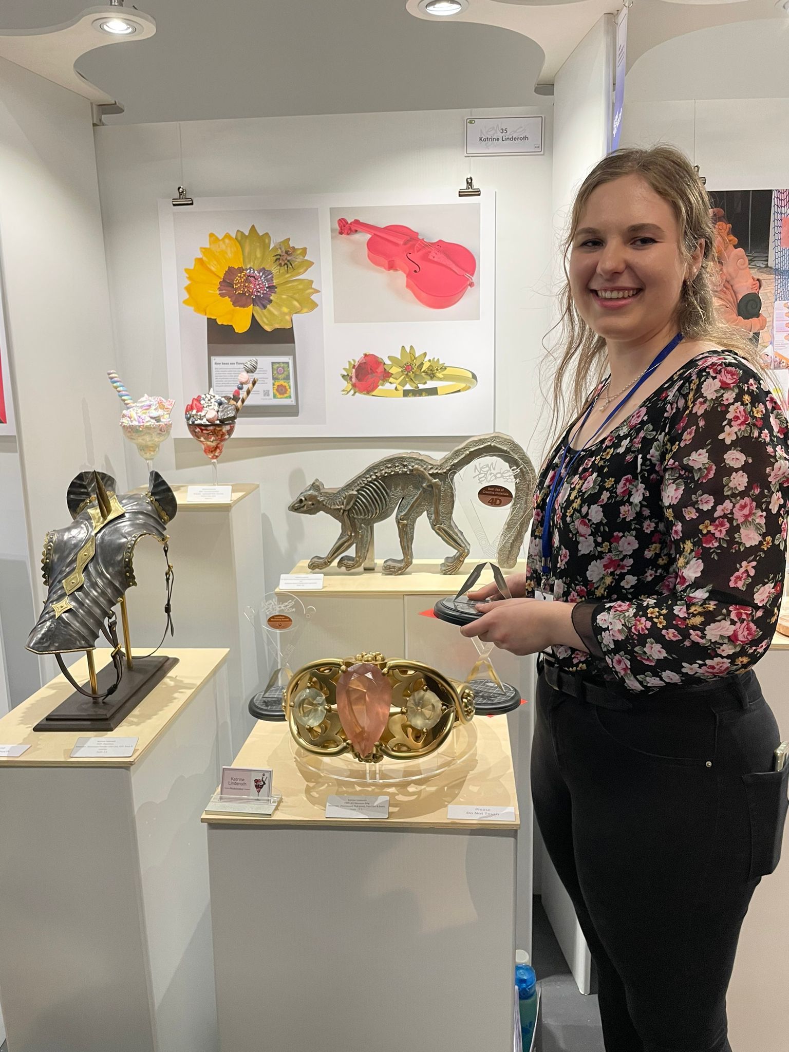 BA (Hons) Modelmaking student K Linderoth standing next to several models at New Blades 2024.