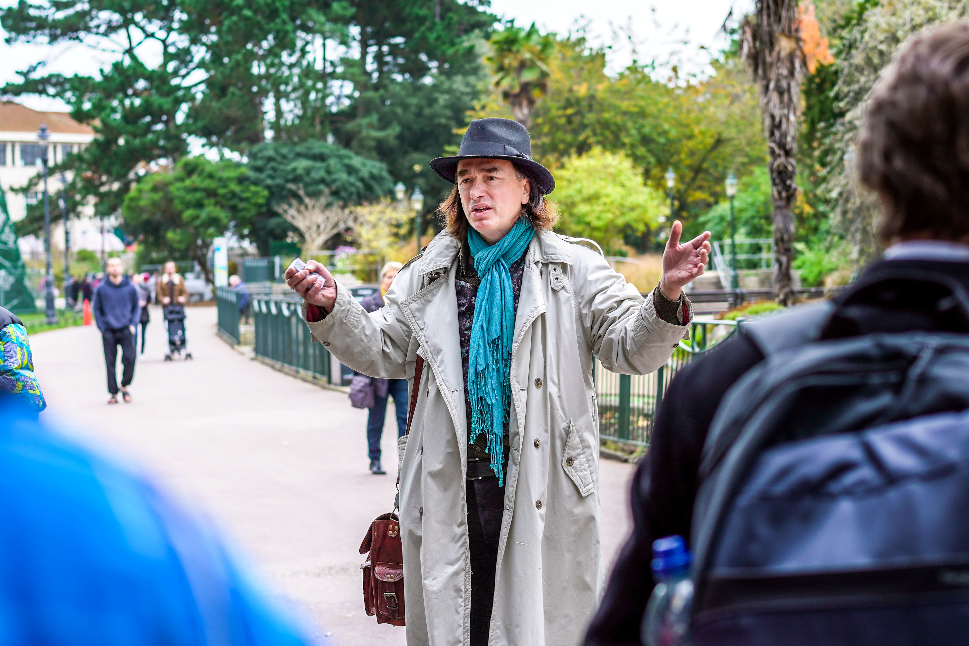 Senior Lecturer in Creative Writing Kevan Manwaring stands on a footpath in Bournemouth Gardens and delivers a workshop to students