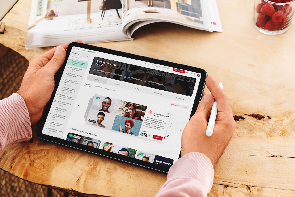 A person holding a tablet and a stylus. A Talentspace app is open on the screen.