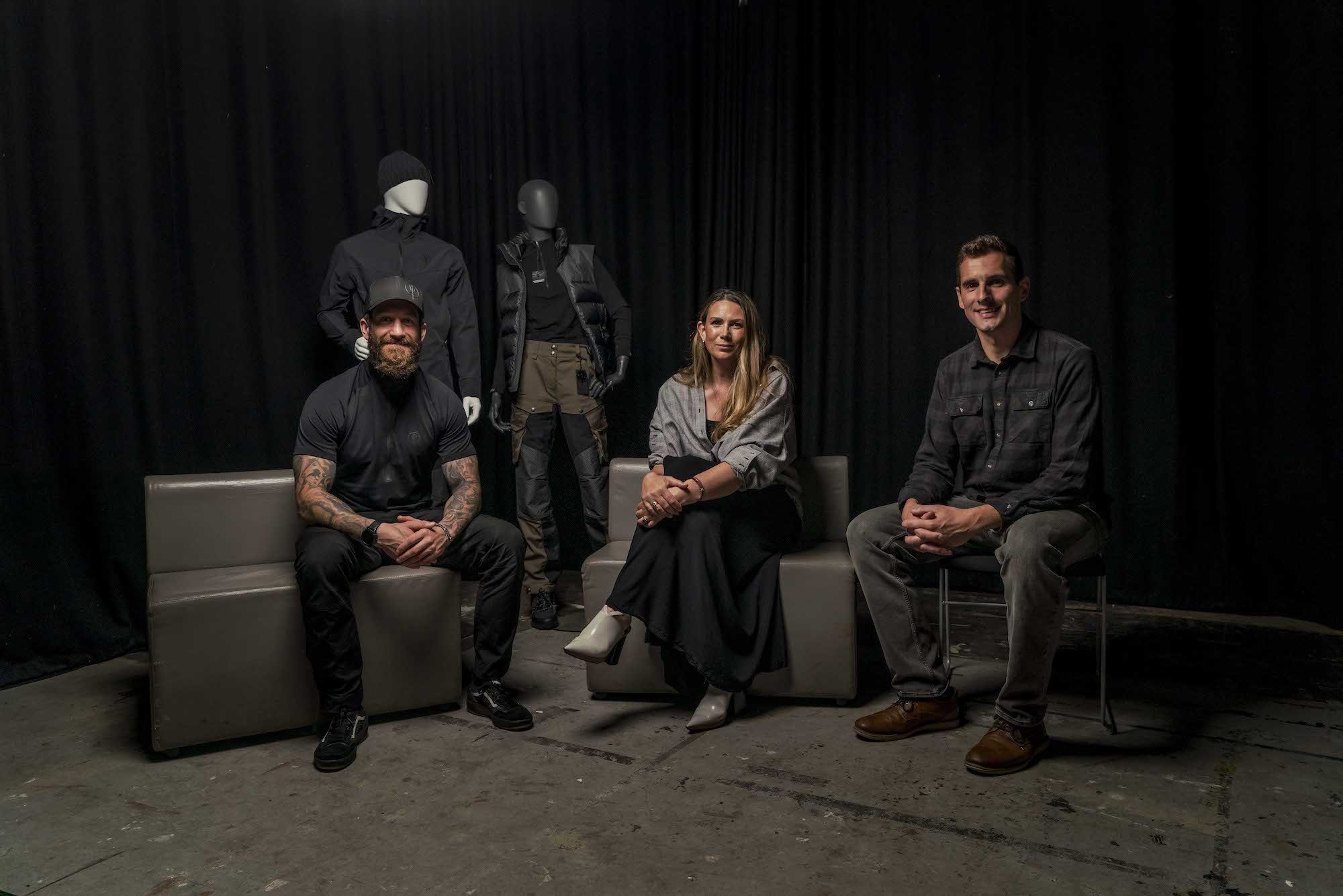 L Tinsley, P Norman and R Fanner sitting in a studio with a pair of mannequins in the background.