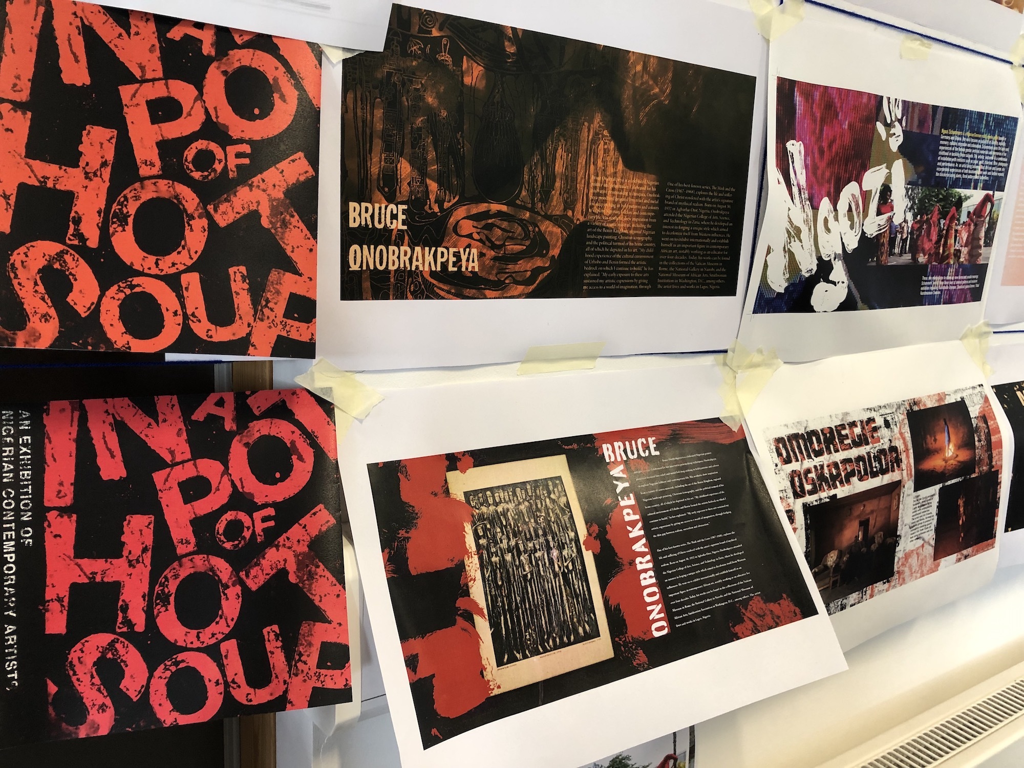 A series of posters with various large-print typography displayed on a wall.