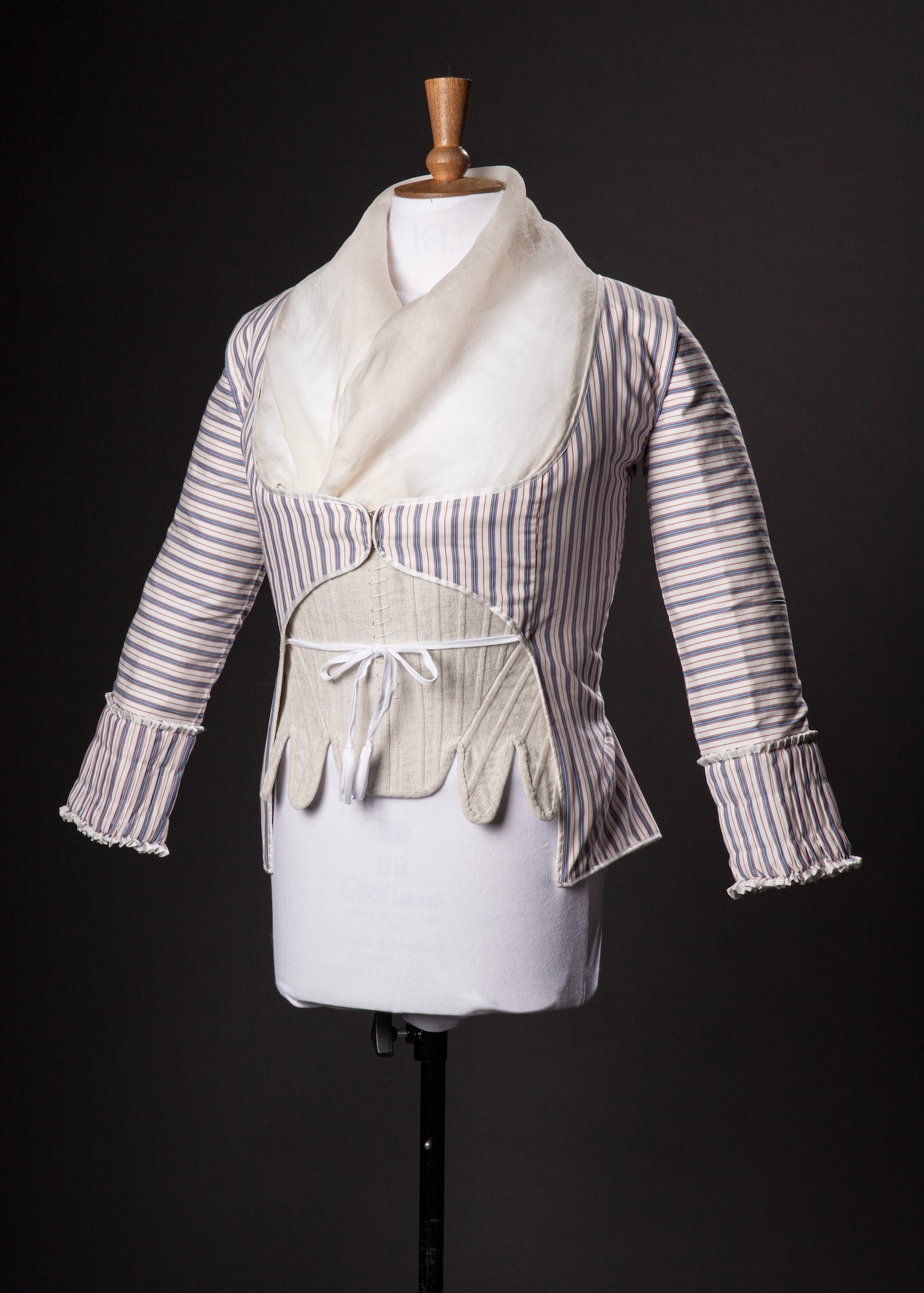 A replica purple-striped caraco jacket on display on a mannequin against a black background.